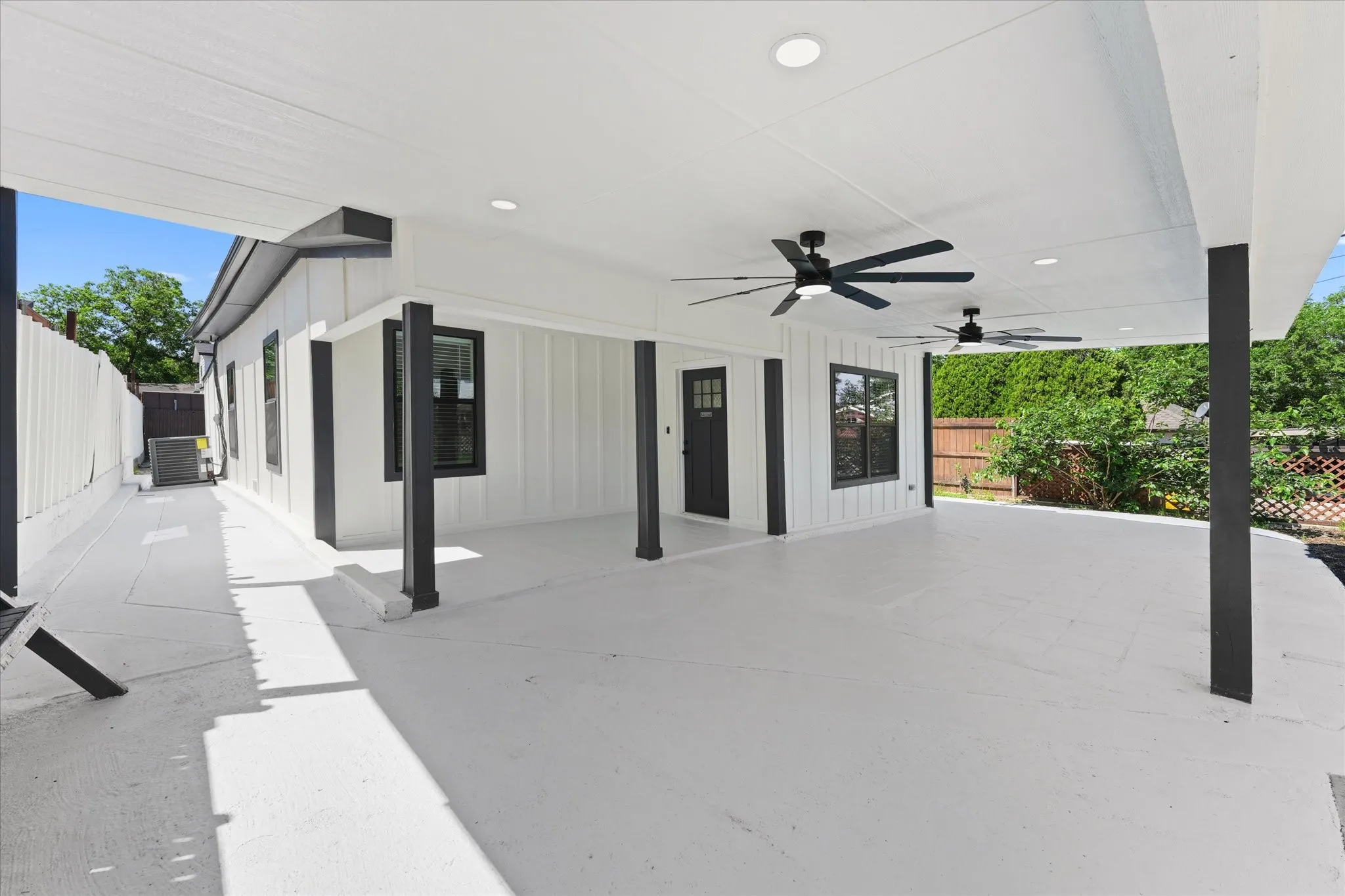 Expansive covered patio featuring a white finish, multiple ceiling fans, and recessed lighting