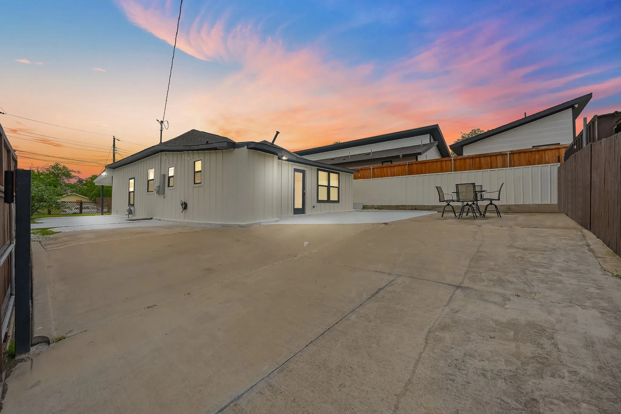 Expansive concrete patio providing ample outdoor living space and parking space.