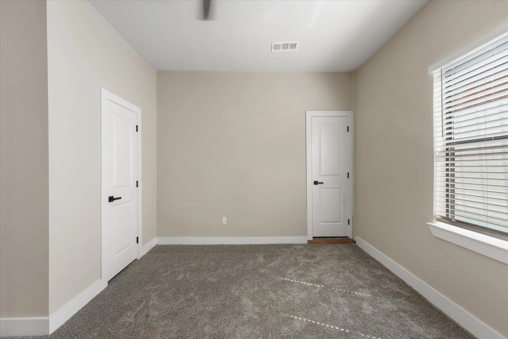 Room #2, Neutral-toned walls complement the gray carpeting