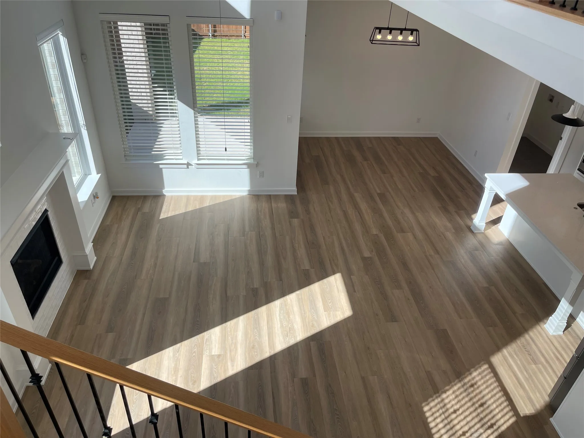 Open-concept living space with wood-finish flooring throughout