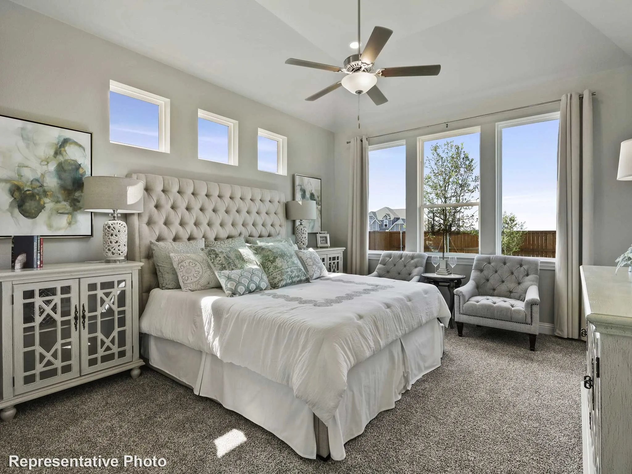 Spacious interior featuring a coffered ceiling, ceiling fan, and carpet flooring