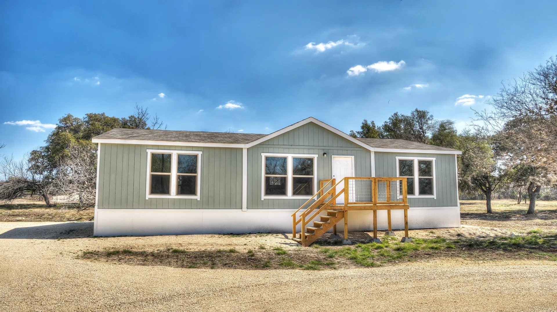 Single-story residence featuring light green siding and white trim