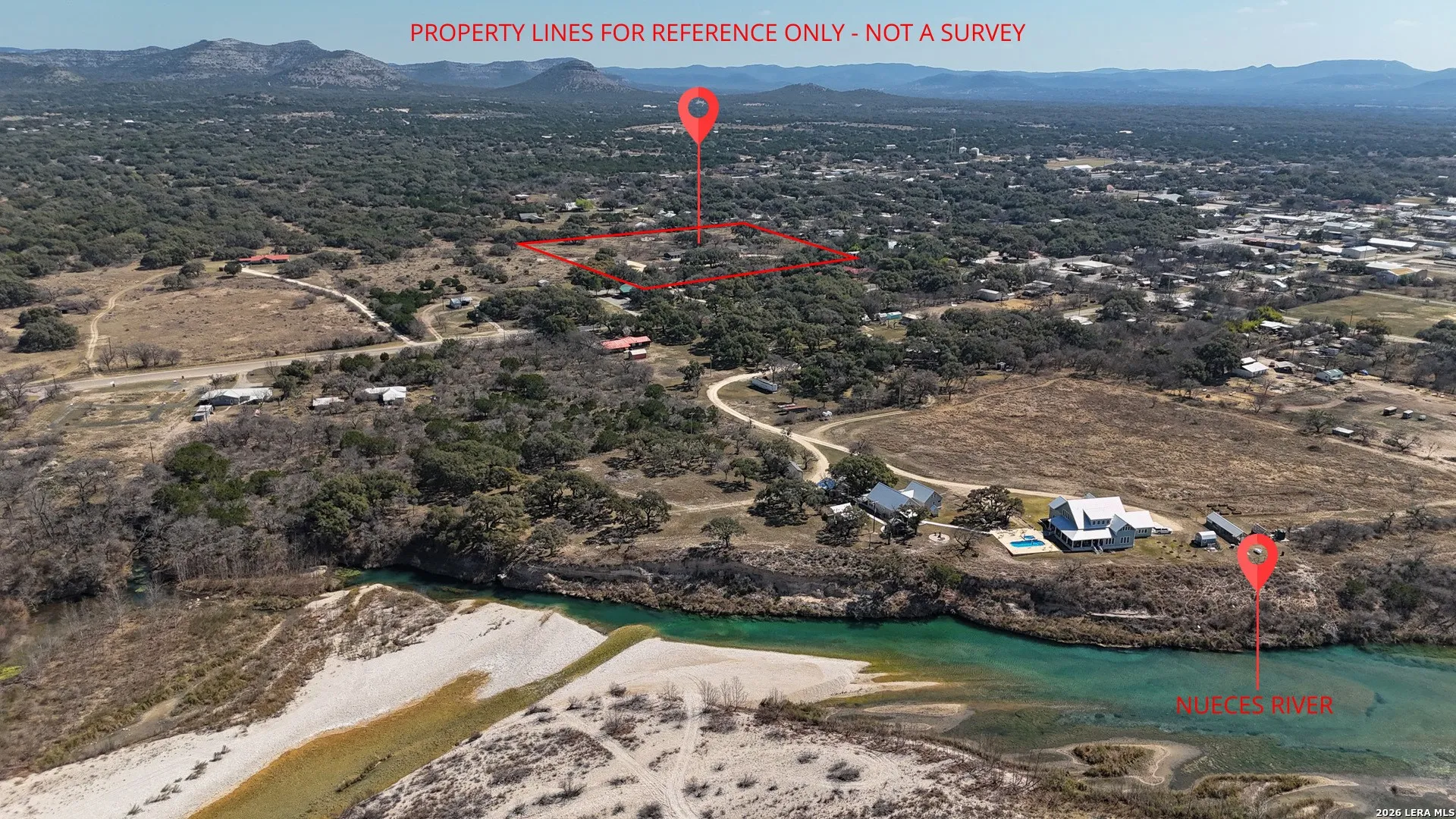Aerial view showcasing a natural landscape with a distinct river bordering the property