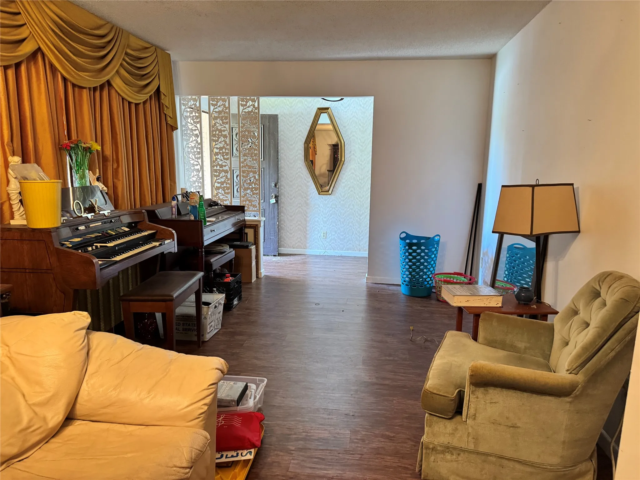 Spacious interior formal living area featuring wood-like flooring.