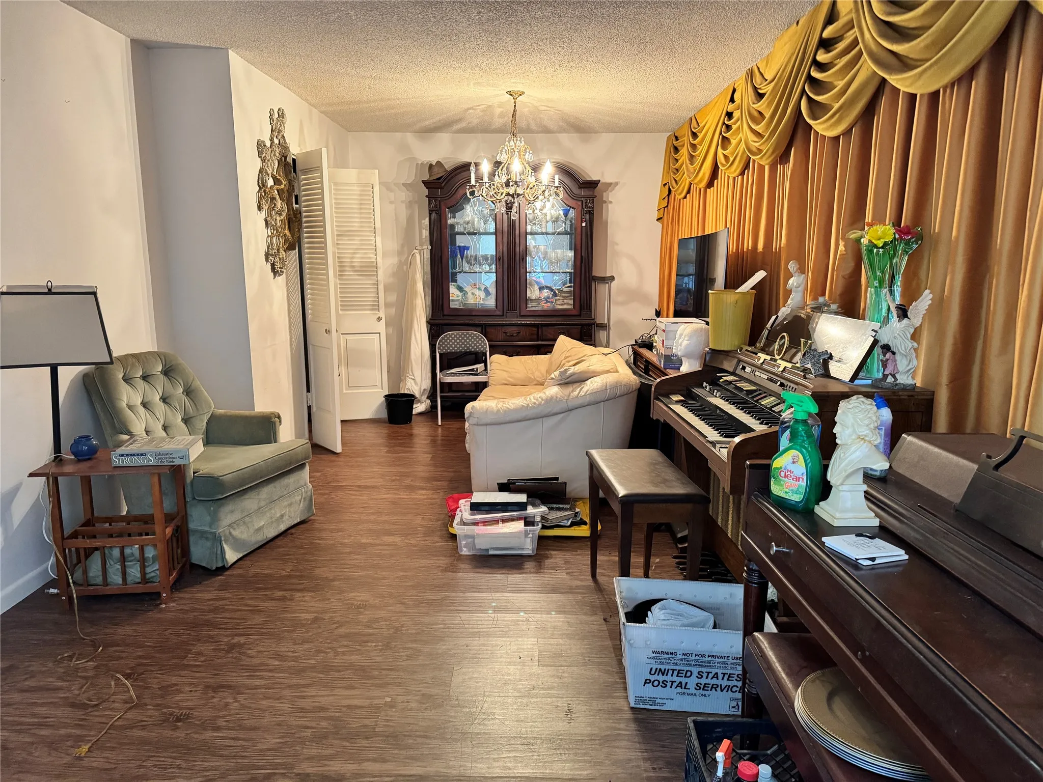 Living space featuring wood-finish flooring with a decorative chandelier.