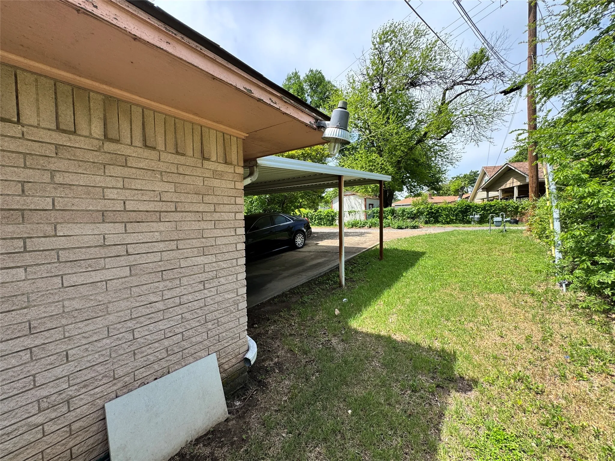 Brick exterior with a covered carport