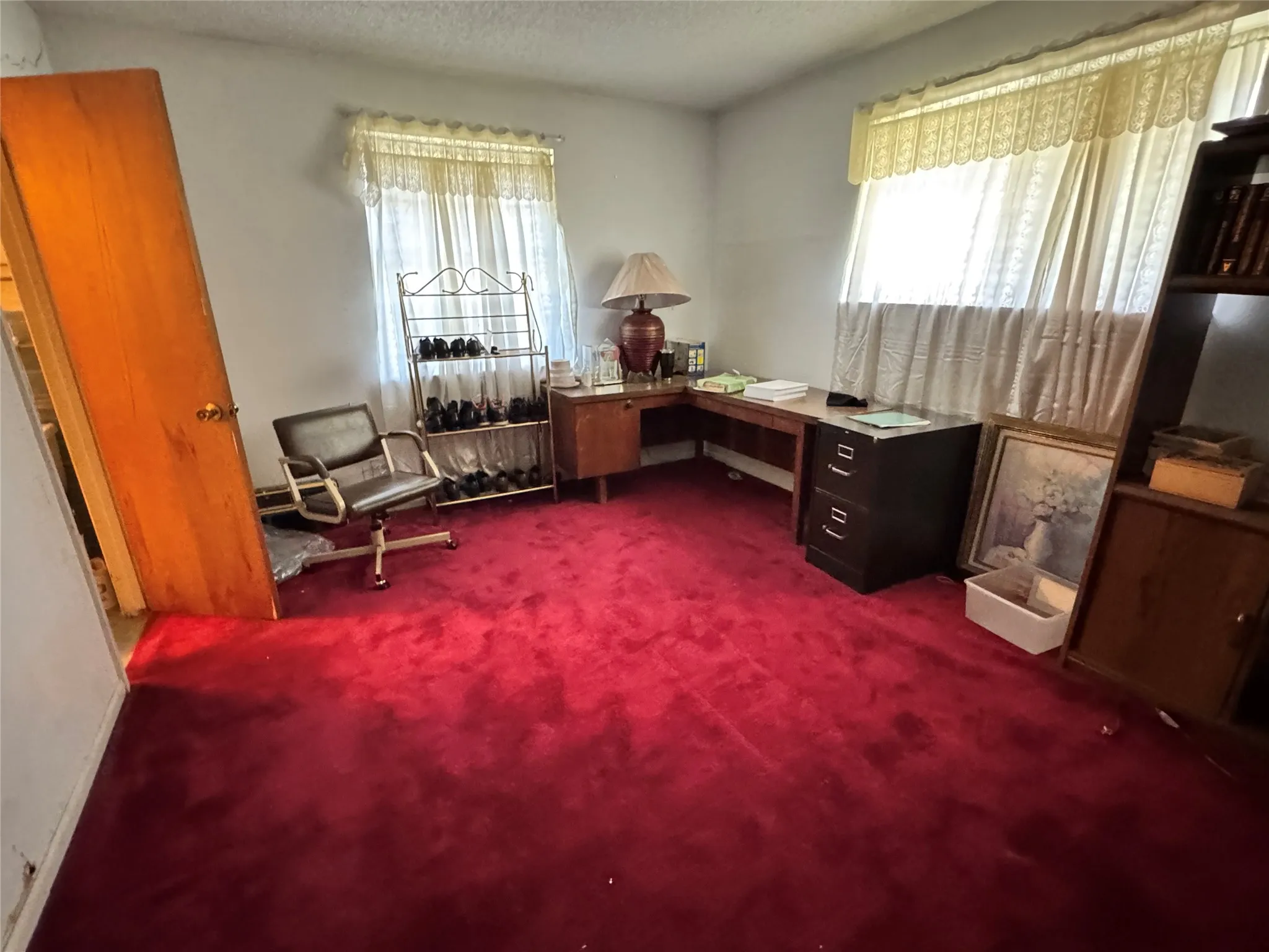 Interior room with vibrant red carpeting and white walls