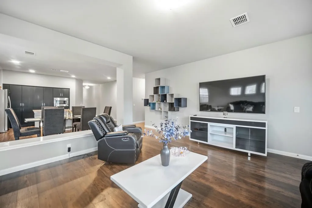 Open concept living space featuring wood-finish flooring