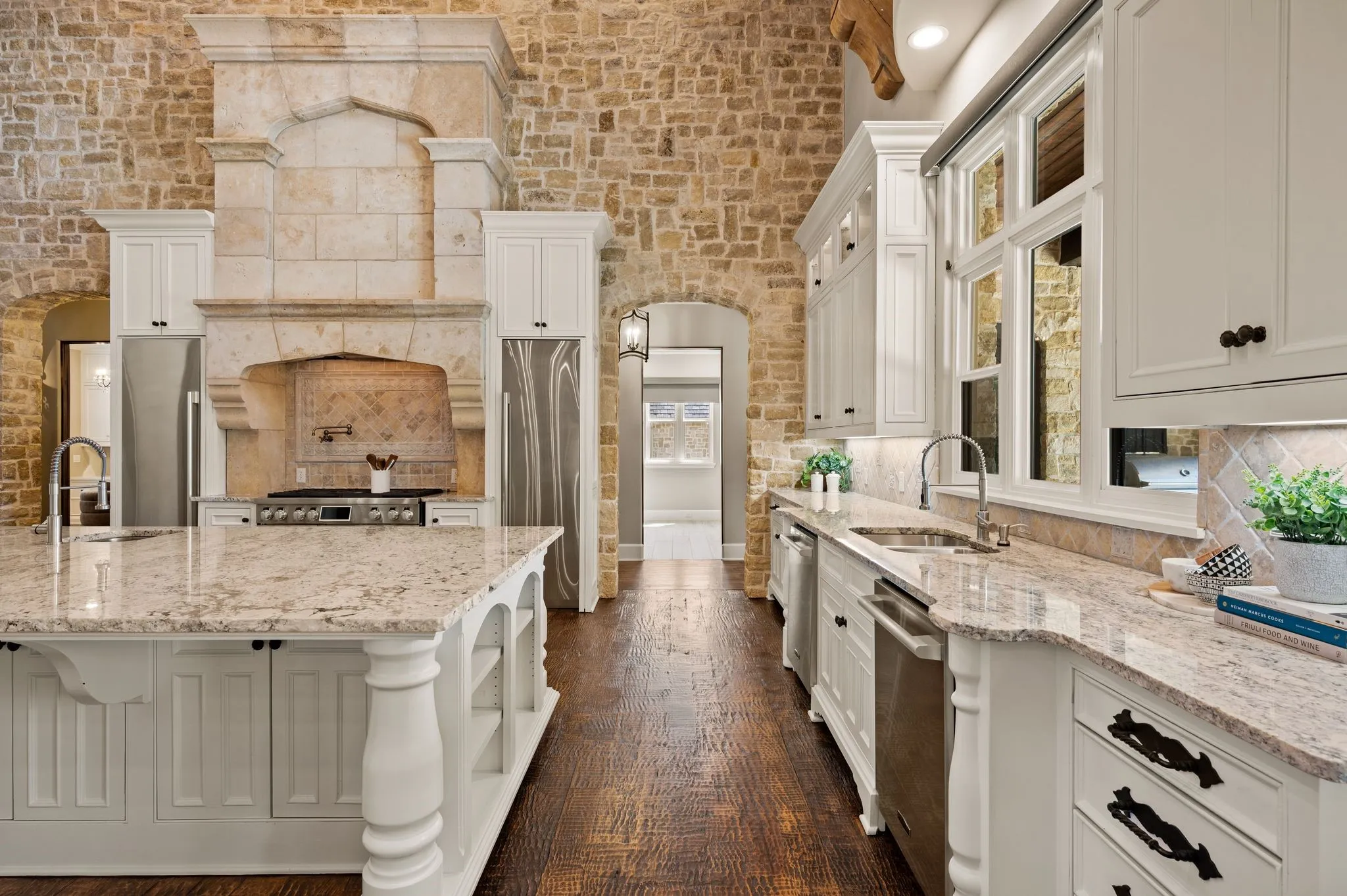 This space still feels cozy anchored in the stone accents and soaring custom beam ceilings.