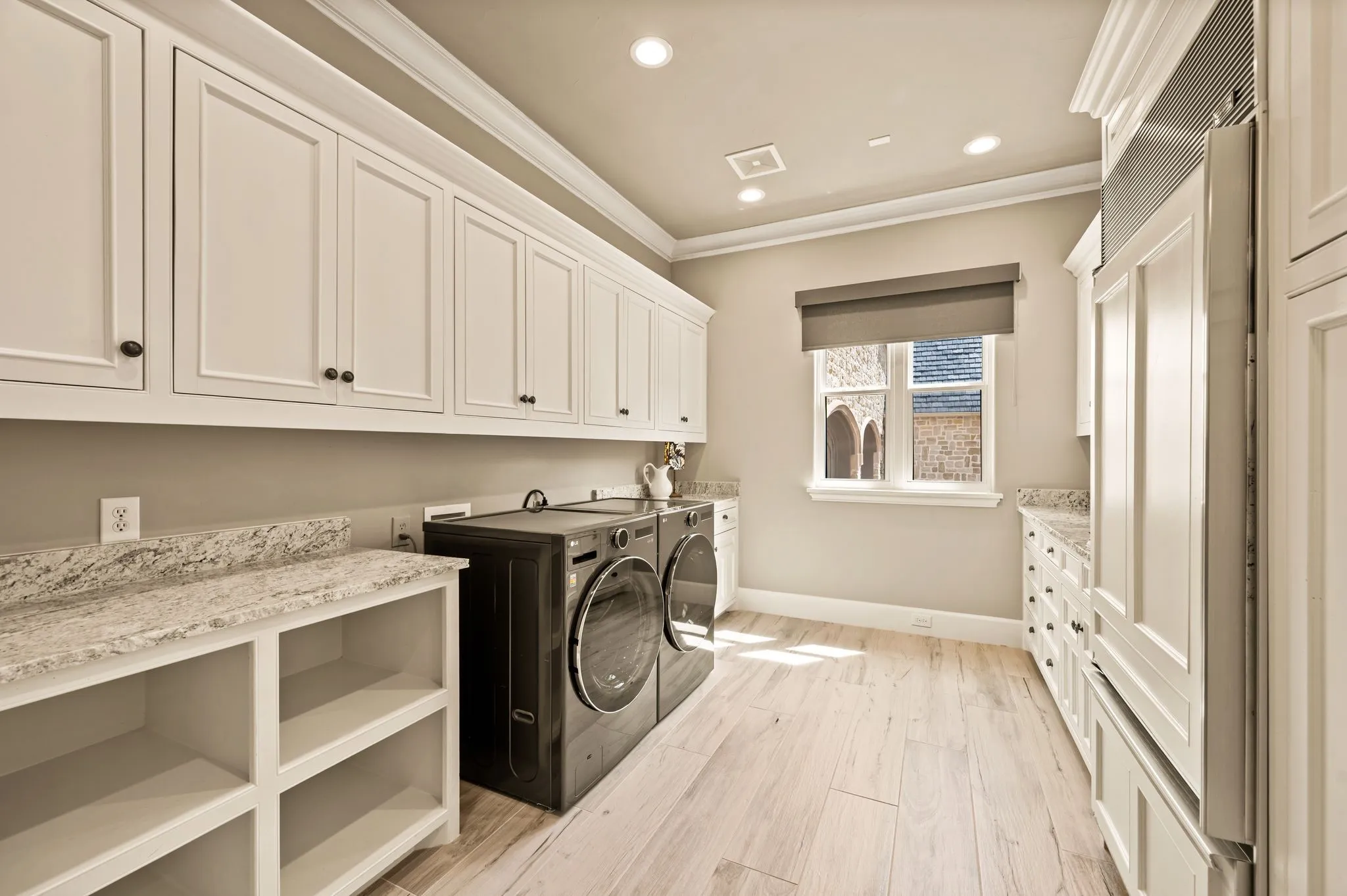 Full-size laundry room includes sink, maximum storage and built in refrigerator there is an additional laundry upstairs.  The home also features a back up generator.