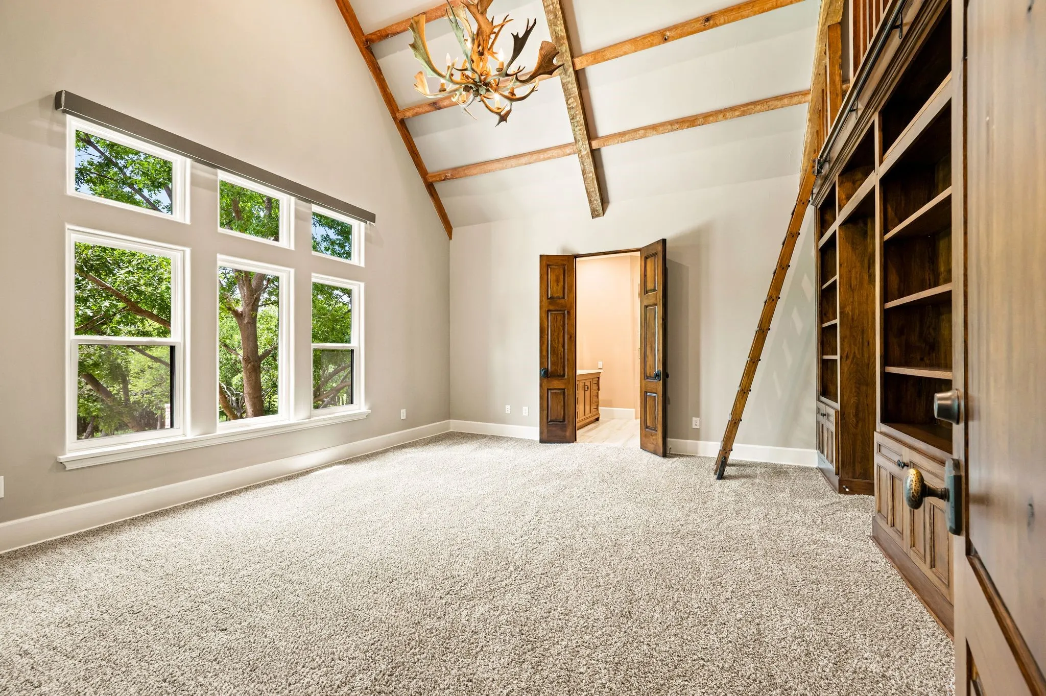 Secondary up bedroom with ensuite baths, and walk in closets.  This bedroom features a fun loft space and custom shelving.
