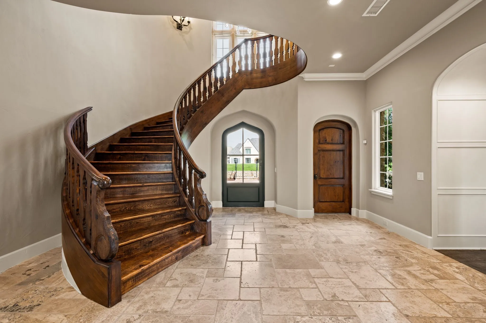 Custom wood staircase greets you upon entering.