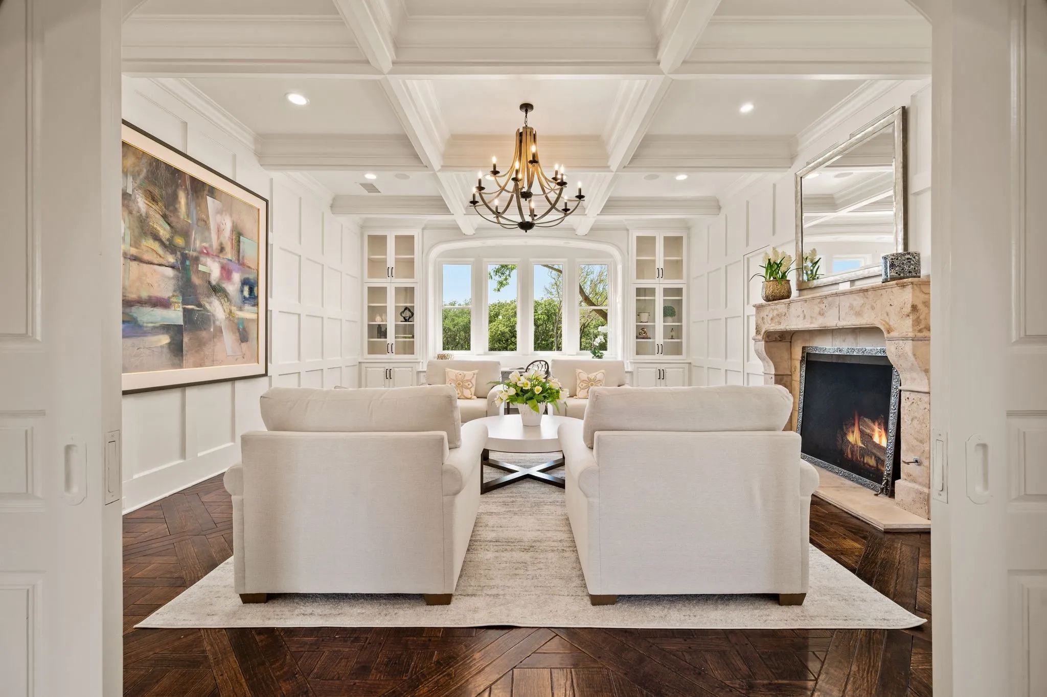 Relax in this formal study with beautiful custom woodwork and view of the grounds.