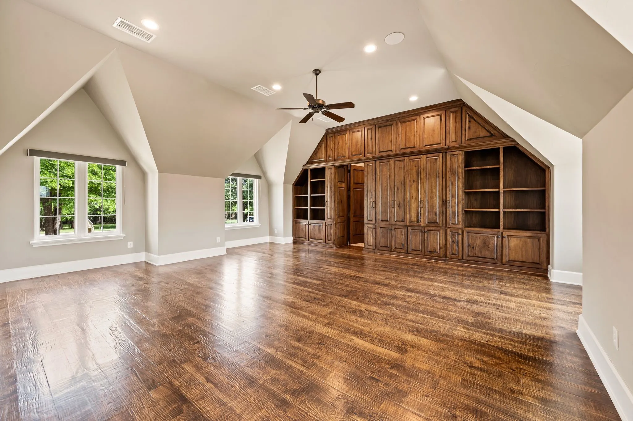 Upstairs gameroom area with built in cabinets.