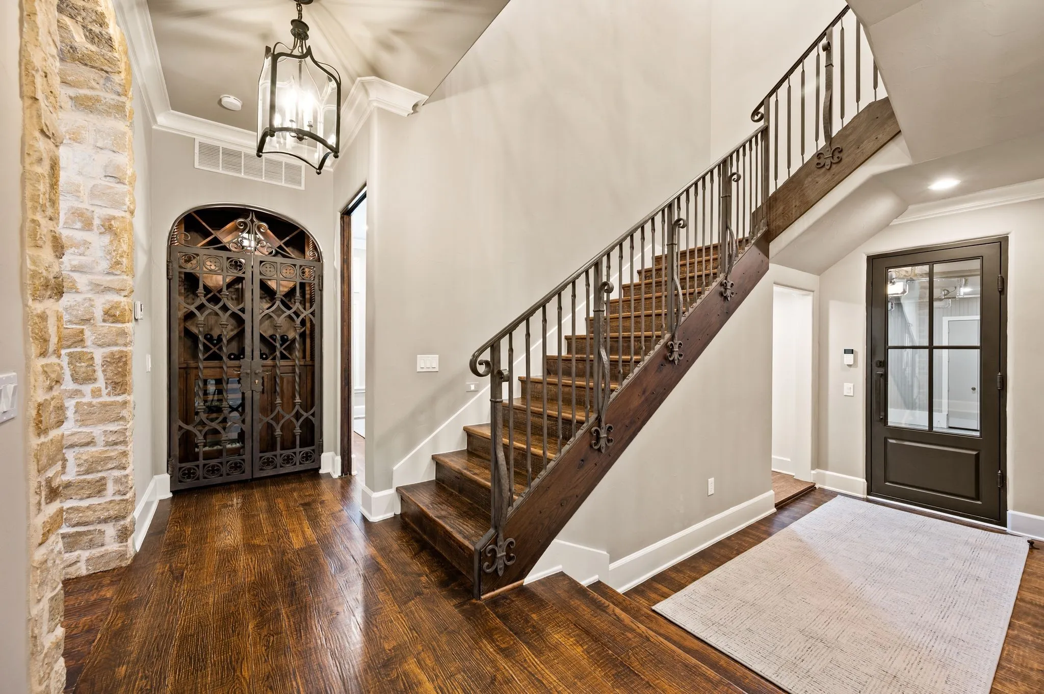 Back staircase located off garage with mud area and additional storage.  One of the garage areas has dual storm shelters.