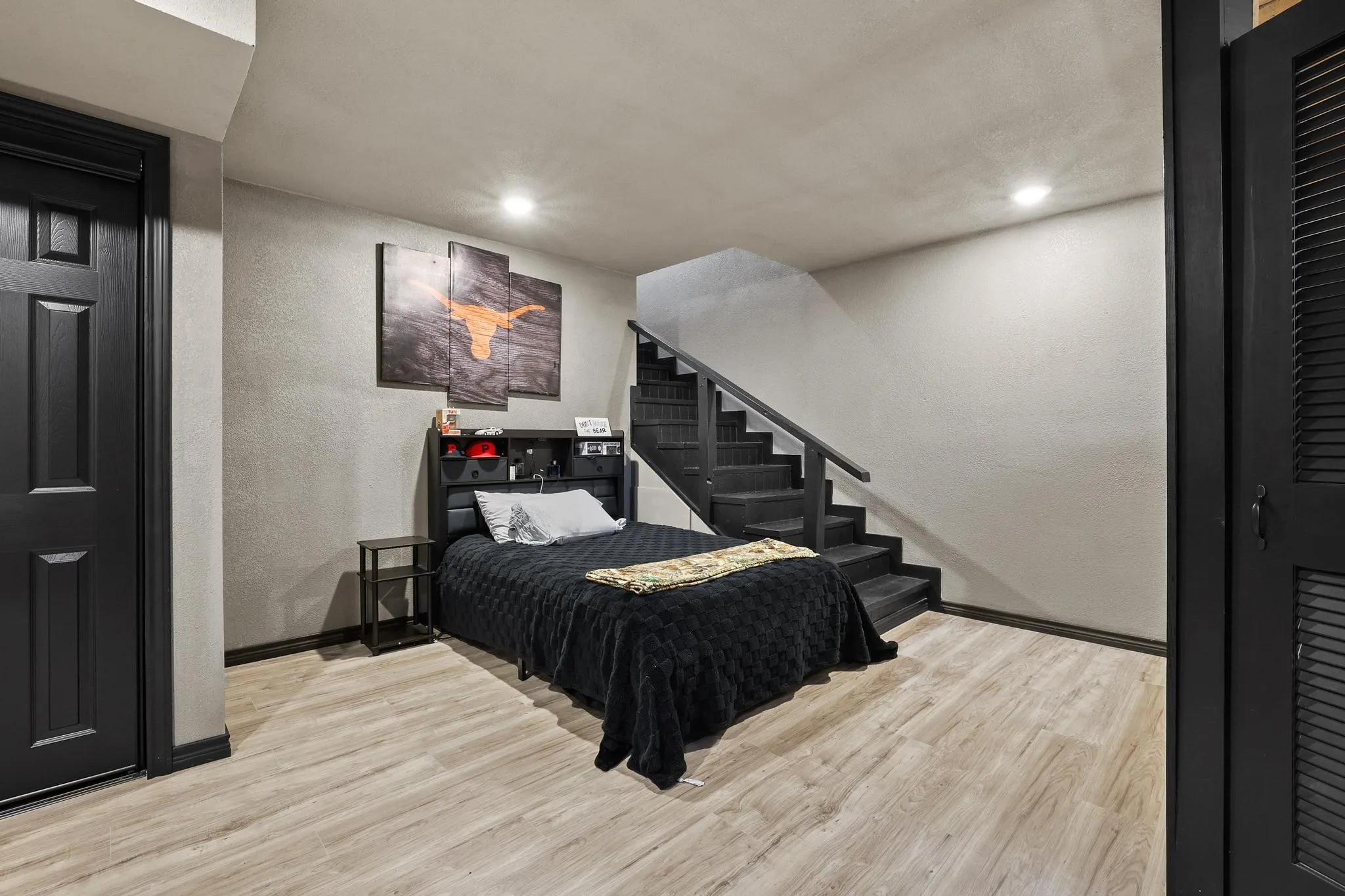 Spacious room featuring wood-finish flooring and recessed lighting