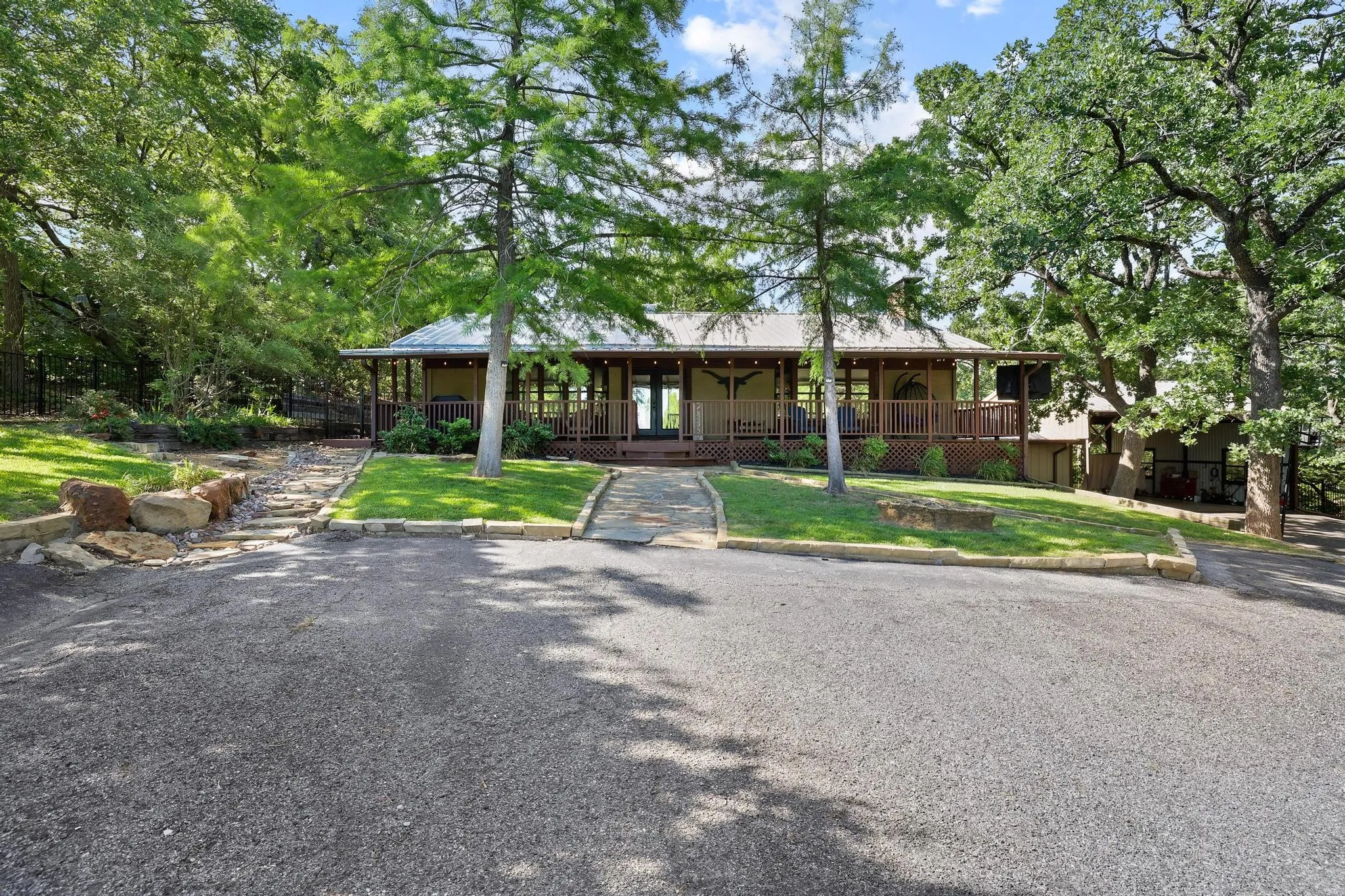 Expansive front drive with direct access to a covered porch entry