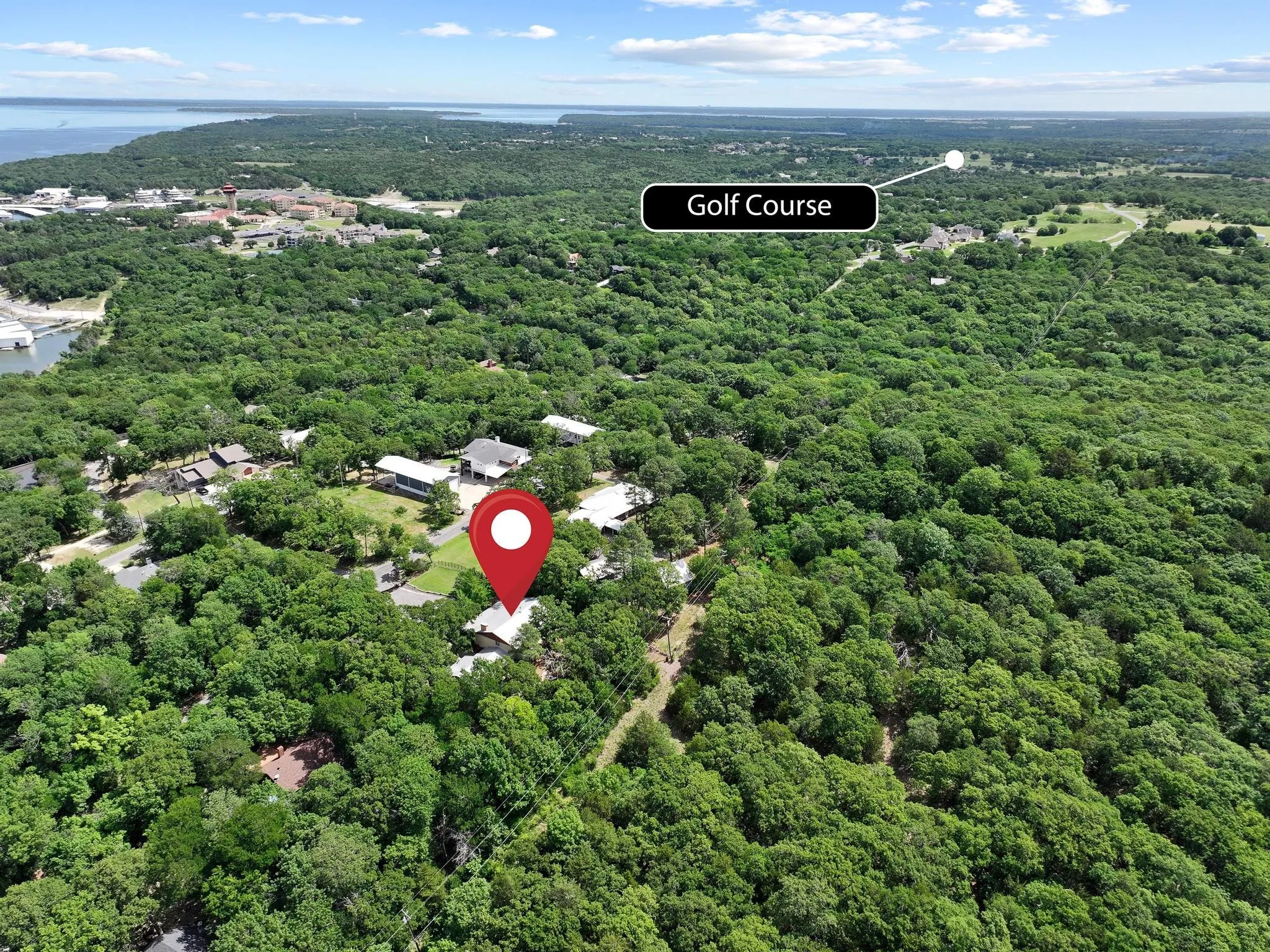 Aerial overview showcasing a property nestled within a densely wooded landscape