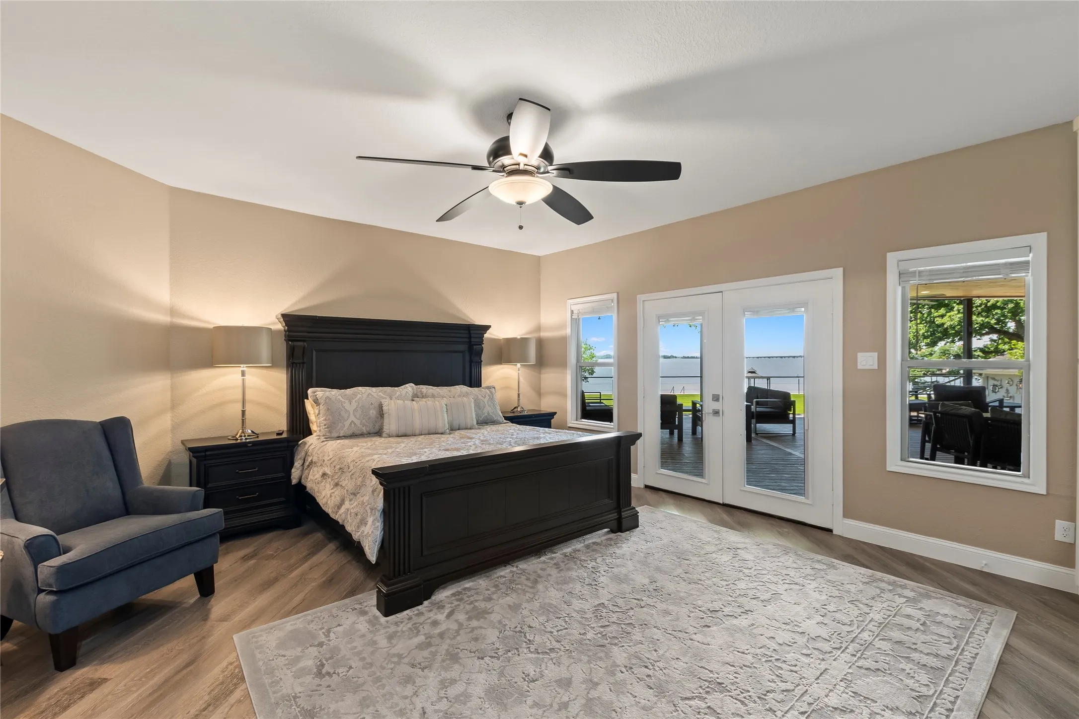 Waterside Primary Suite with direct deck access, ensuite bath and walk in closet.