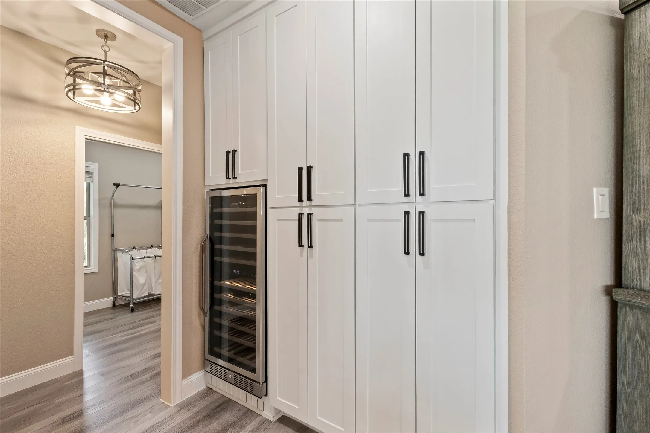 Large wine refrigerator ready for entertaining.
Pantry-style cabinetry offers abundant storage.