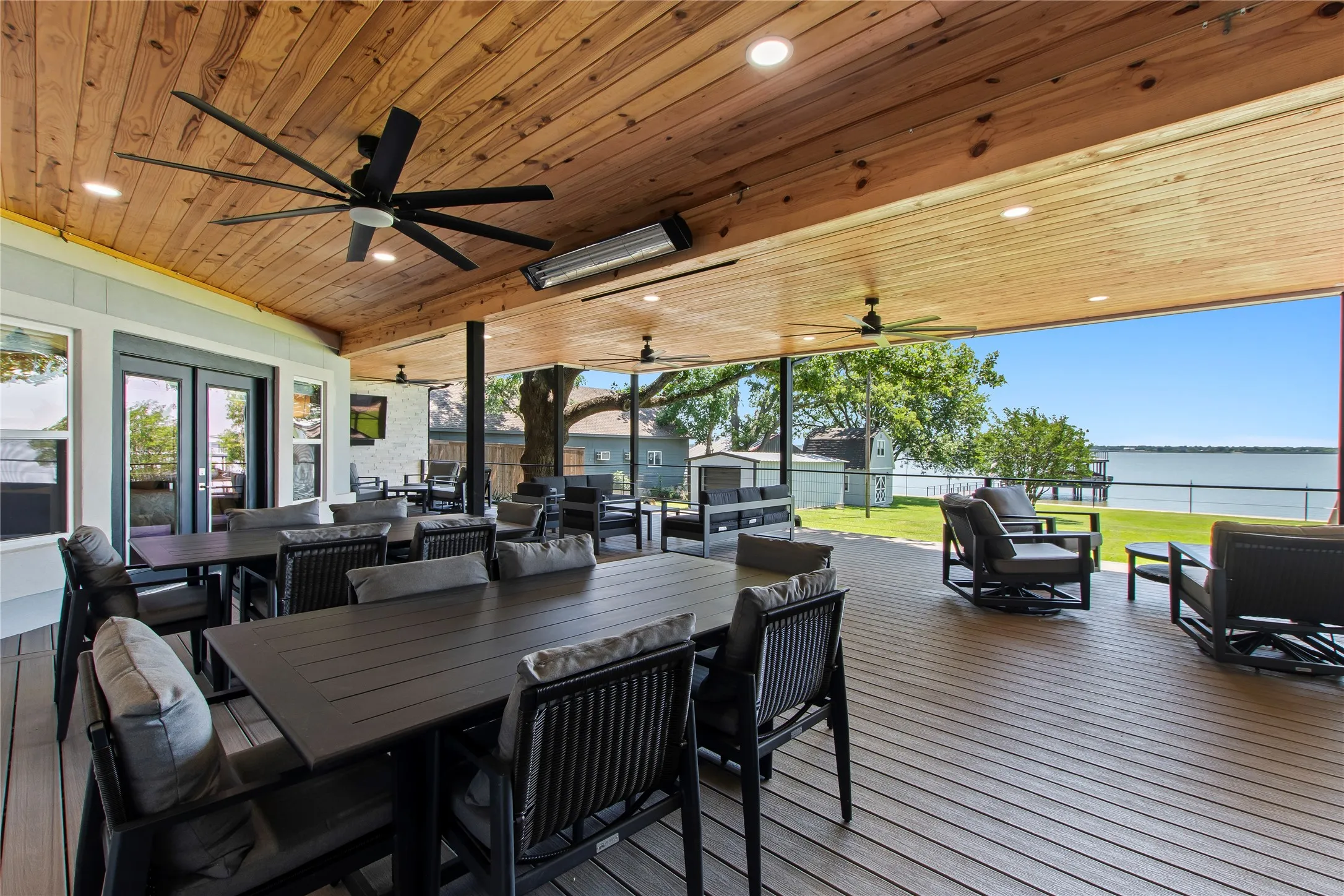 Resort-style outdoor living designed for year-round enjoyment with mosqutio misting system, heaters, and ceiling fans.
