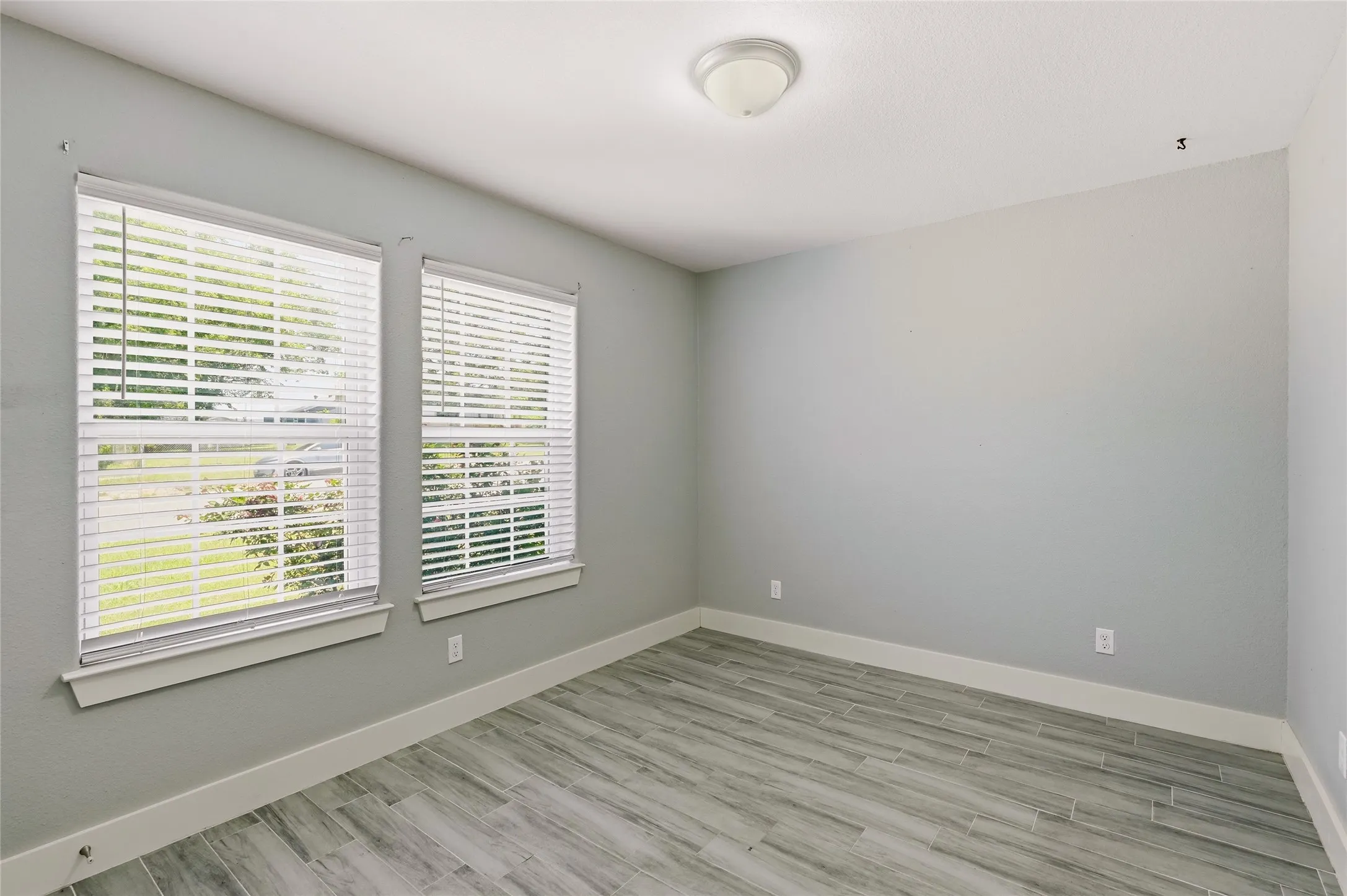 Bedroom #2, ceramic tile flooring, outlets on every walll.