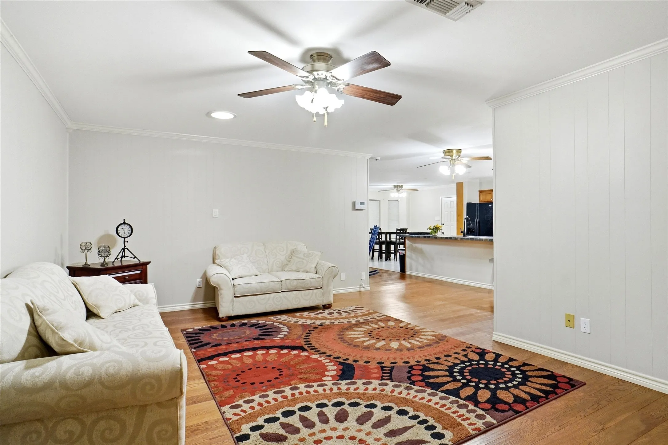 Spacious common area featuring wood-finish flooring, recessed lighting, and a ceiling fan