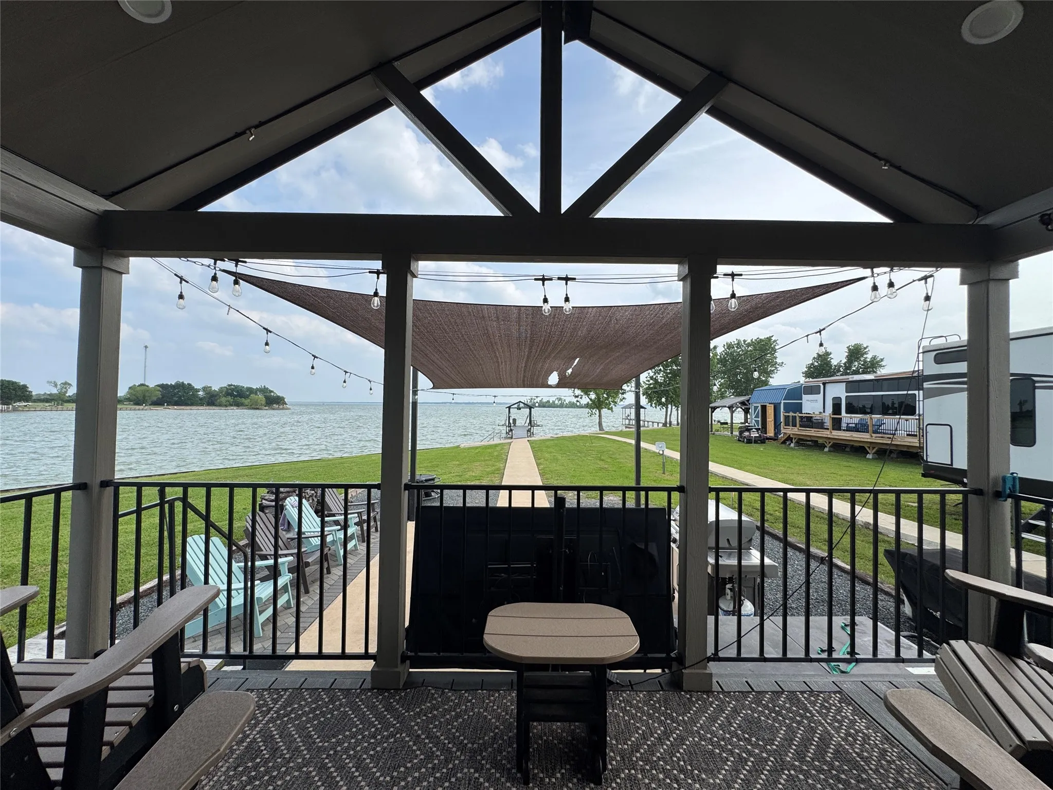 Covered patio with integrated string lighting and a durable outdoor rug
