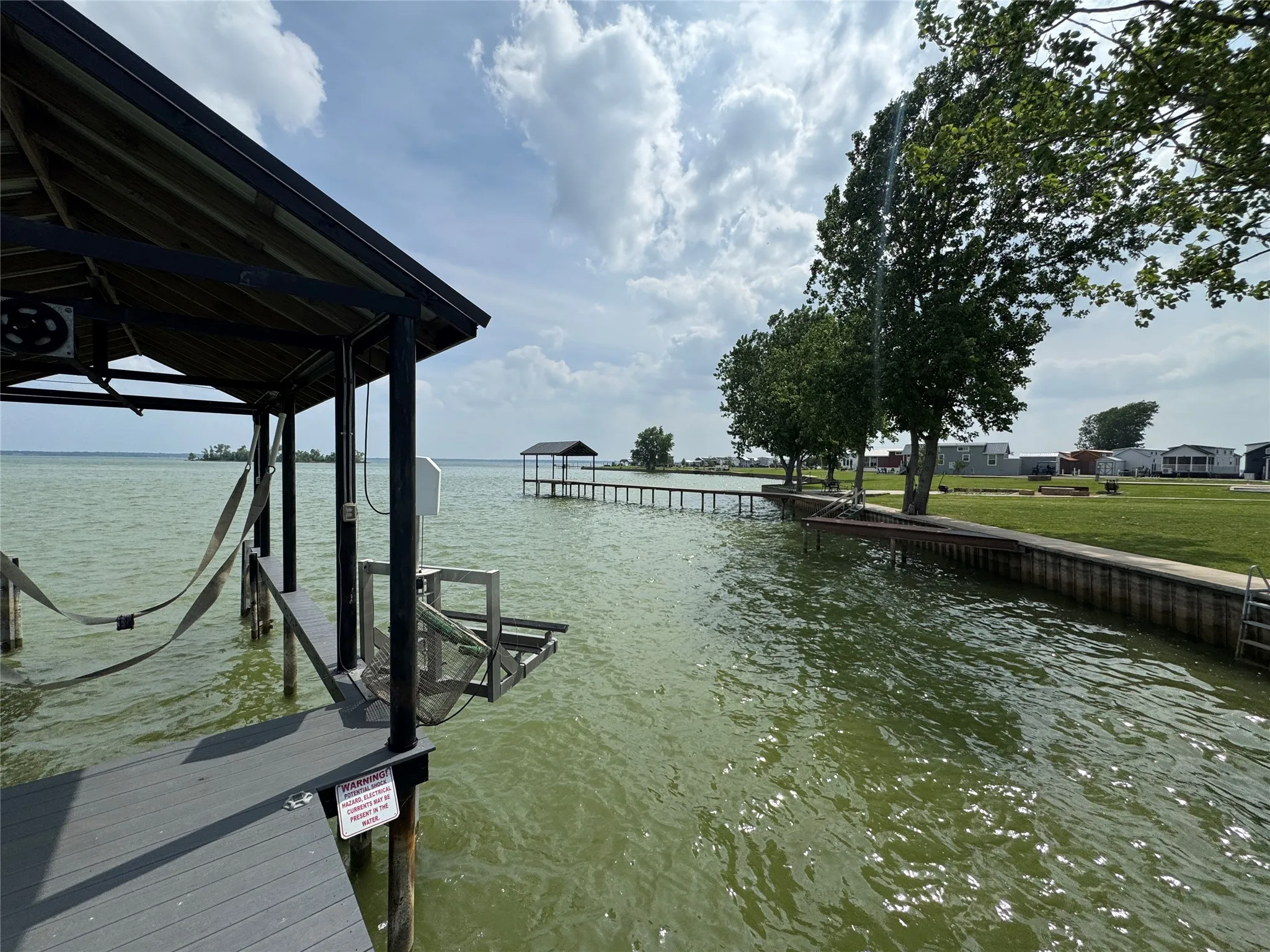 Covered dock with boat lift, composite decking, and direct water access