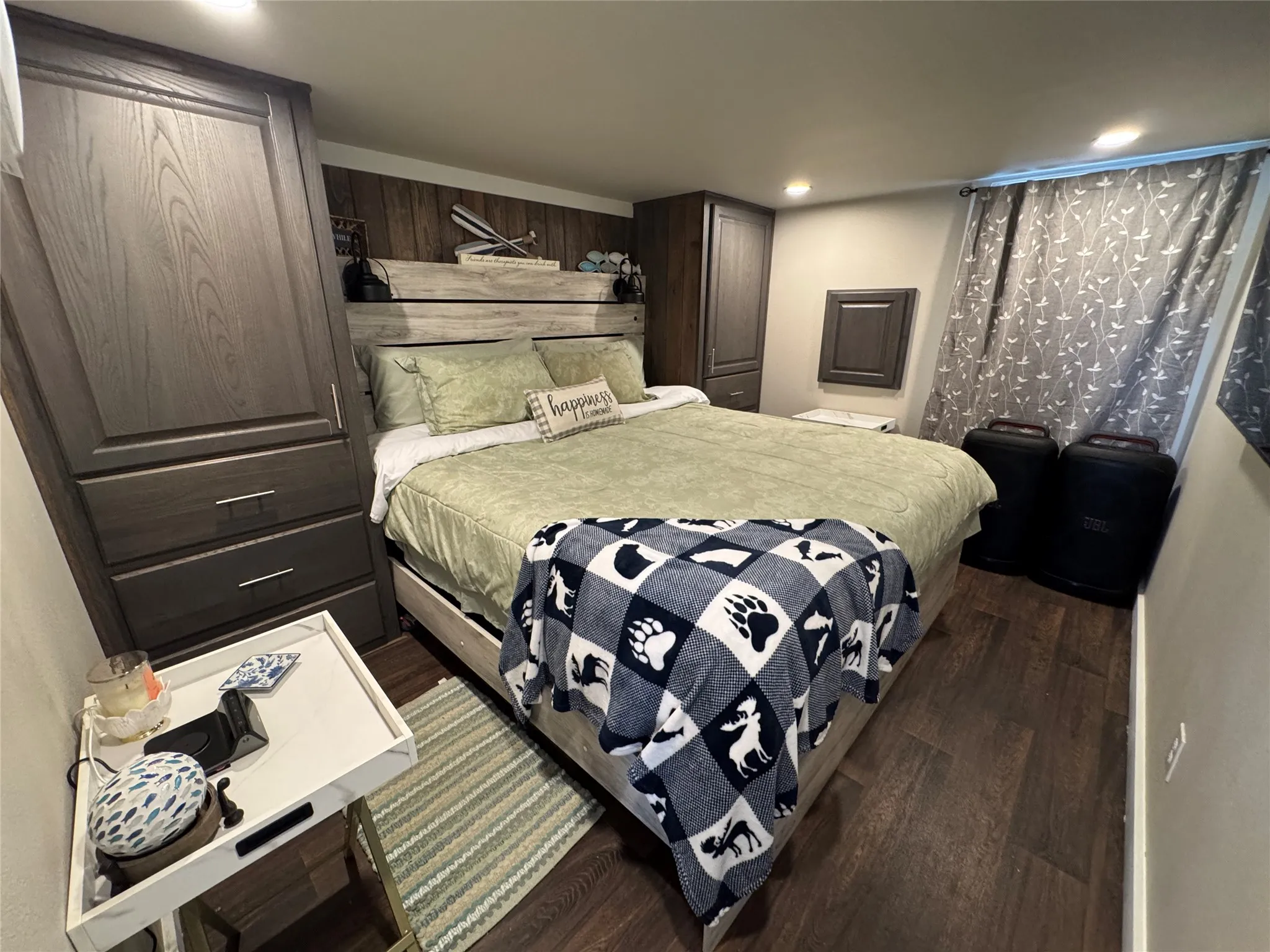 Bedroom featuring wood-finish flooring, recessed lighting, and built-in cabinetry with brushed nickel hardware
