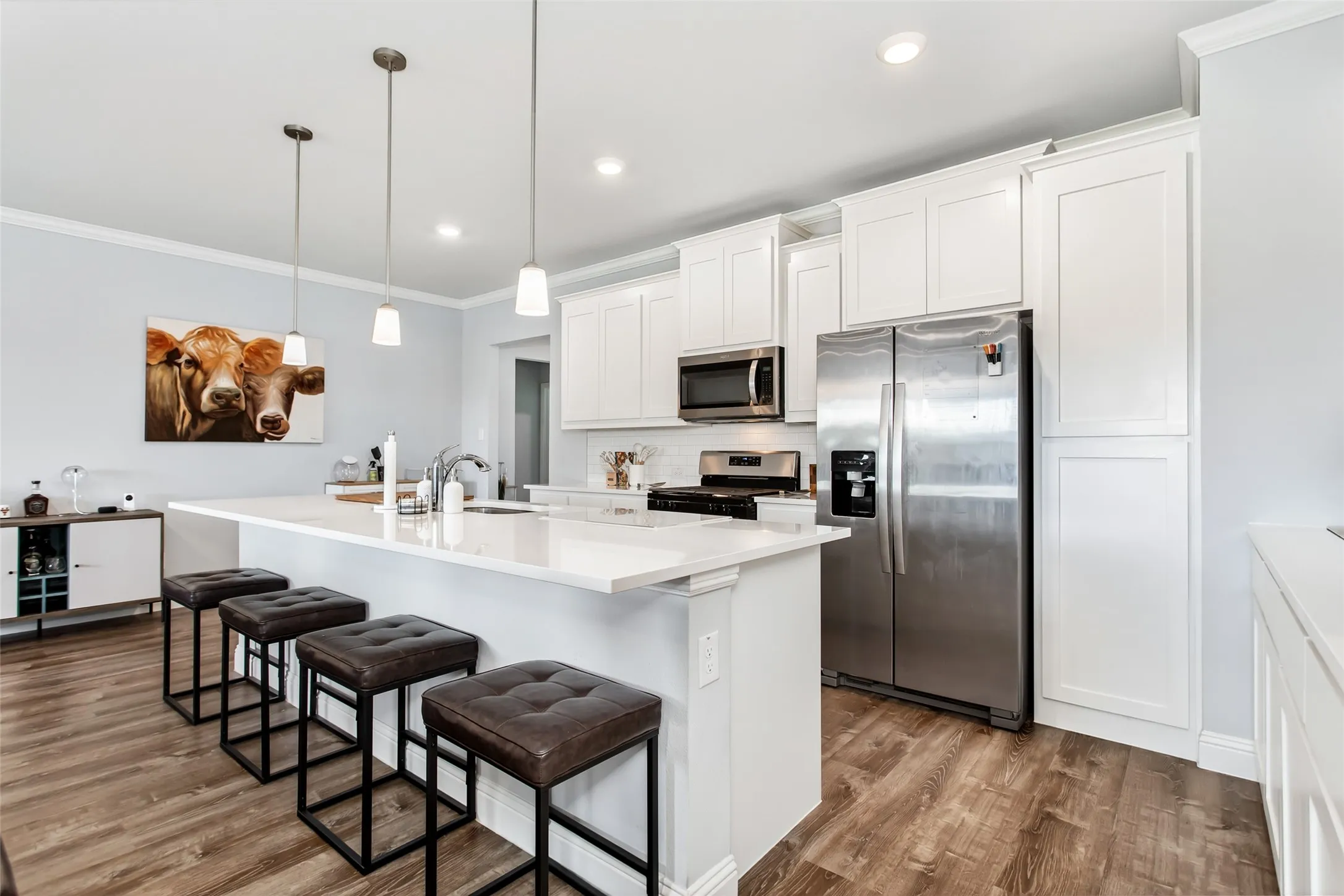 Large center island with seating and sink creates the perfect hub for cooking, hosting, and staying connected with family and guests.