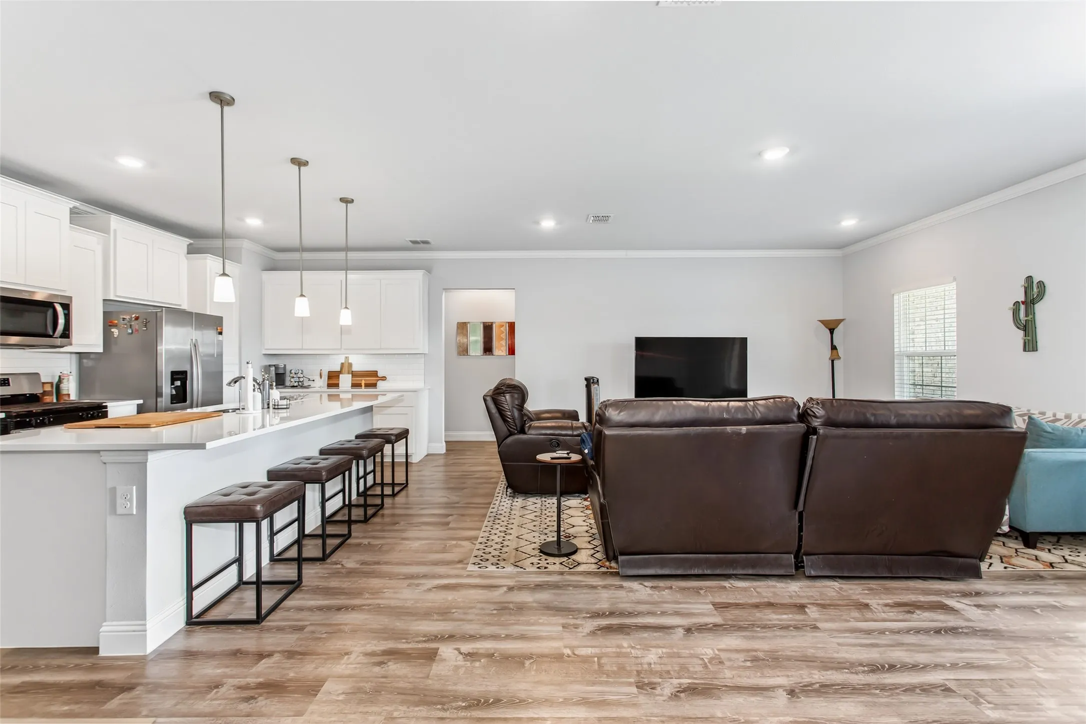 Spacious open living area with abundant natural light, recessed lighting, and seamless flow to the kitchen—perfect for entertaining and everyday living.