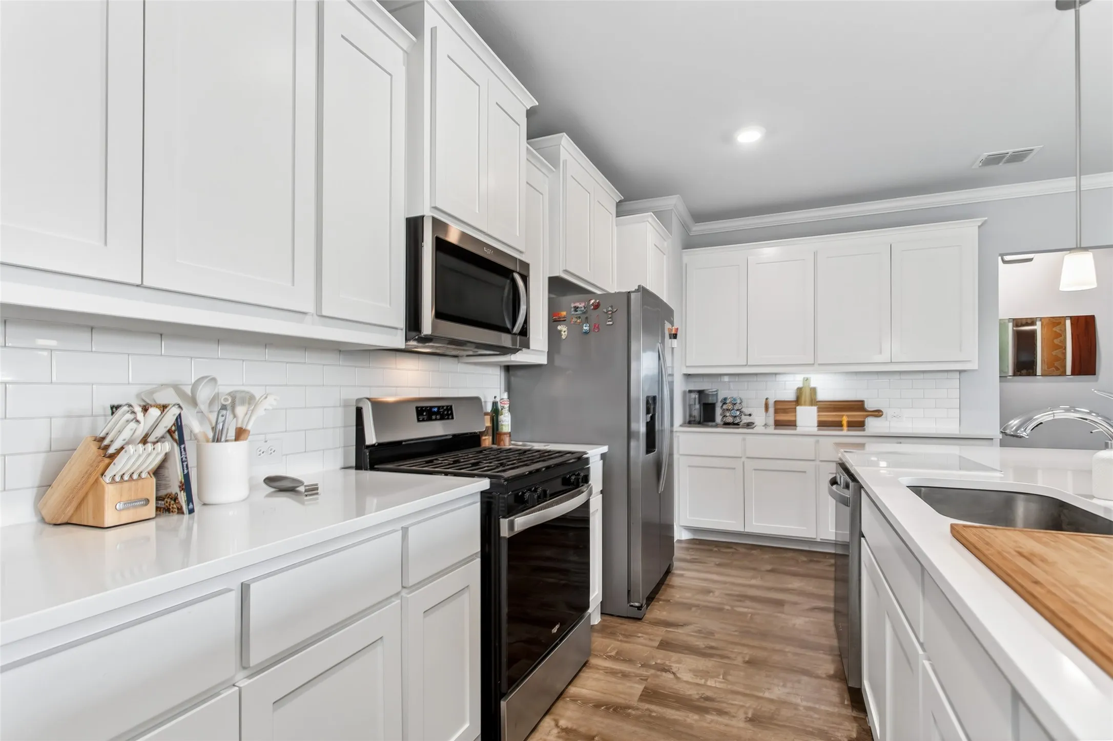 Spacious layout with ample counter space, gas range, and extensive storage makes this kitchen as functional as it is beautiful.