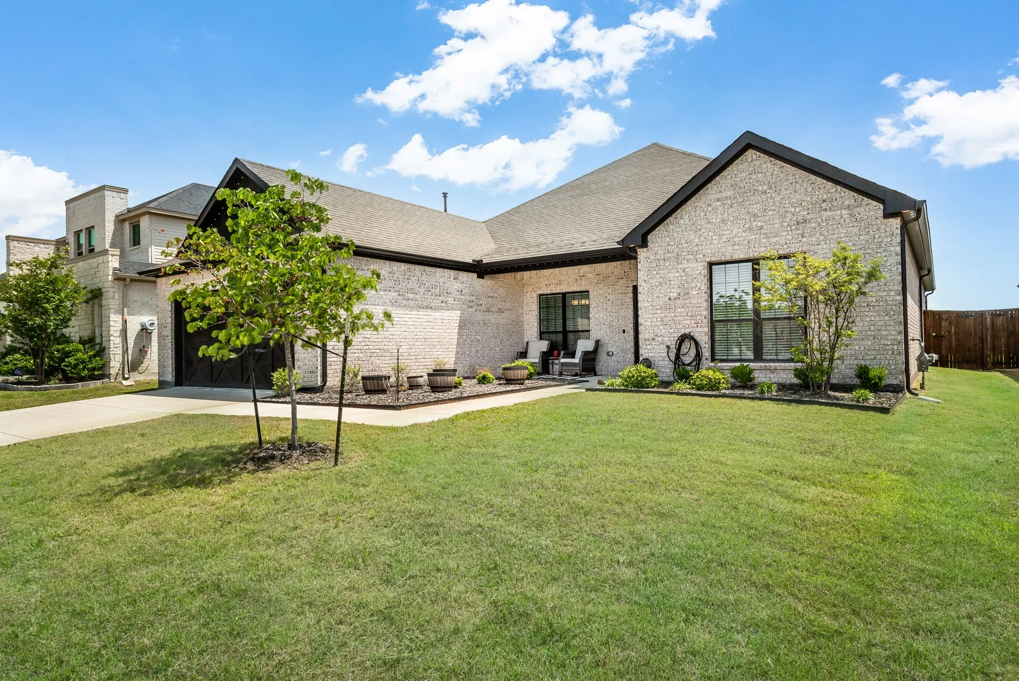 Relax and unwind on the inviting covered front porch surrounded by fresh landscaping and a well-maintained yard.