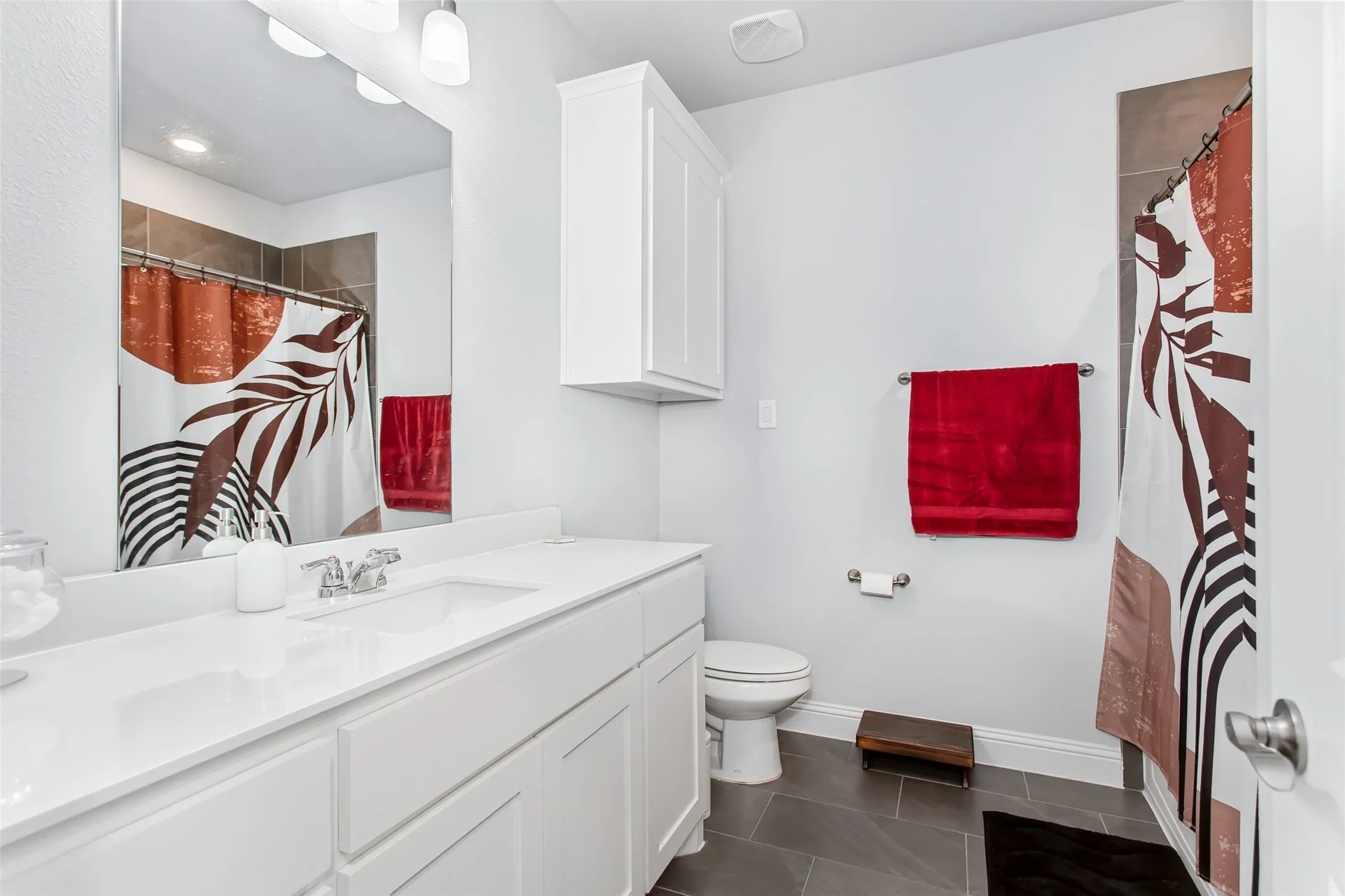 Clean contemporary design with quartz-style countertops, sleek cabinetry, and a tub-shower combination perfect for guests or family.