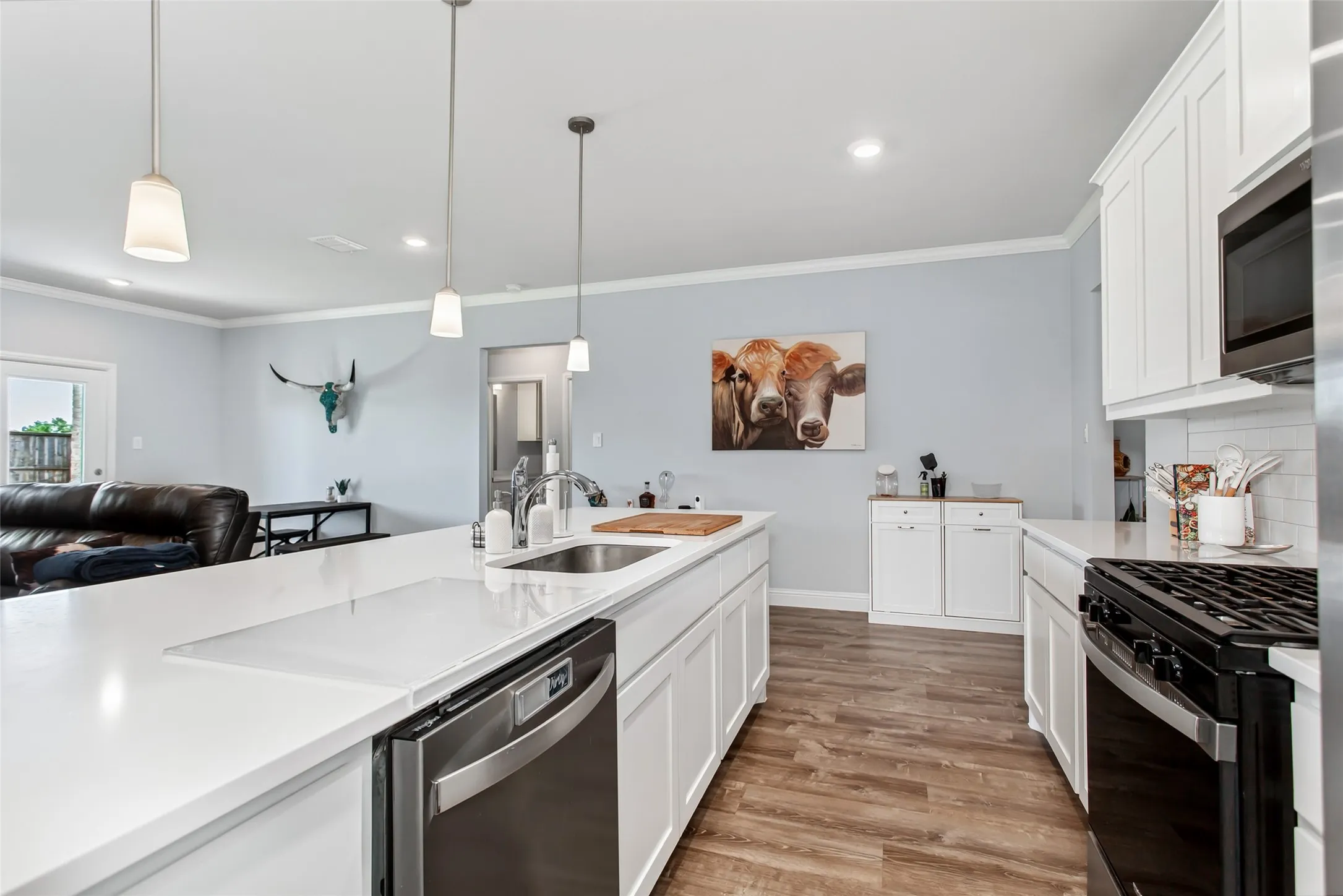 Large center island with seating and sink creates the perfect hub for cooking, hosting, and staying connected with family and guests.