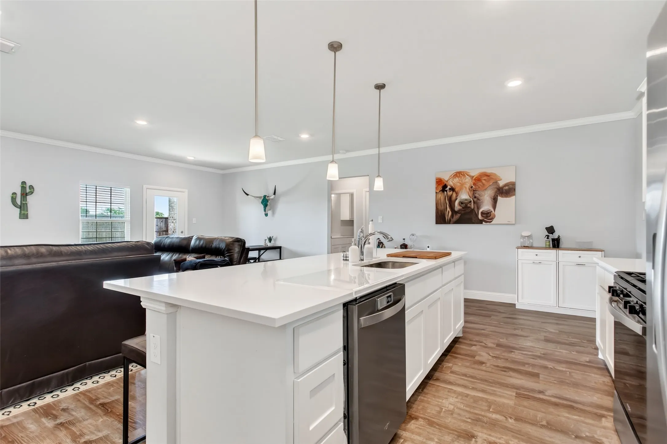 Large center island with seating and sink creates the perfect hub for cooking, hosting, and staying connected with family and guests.