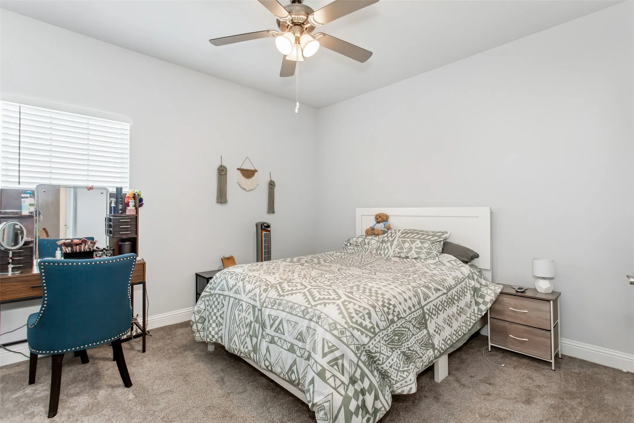 Bright and comfortable bedroom with soft natural light, modern finishes, and flexible space for work, study, or relaxation.