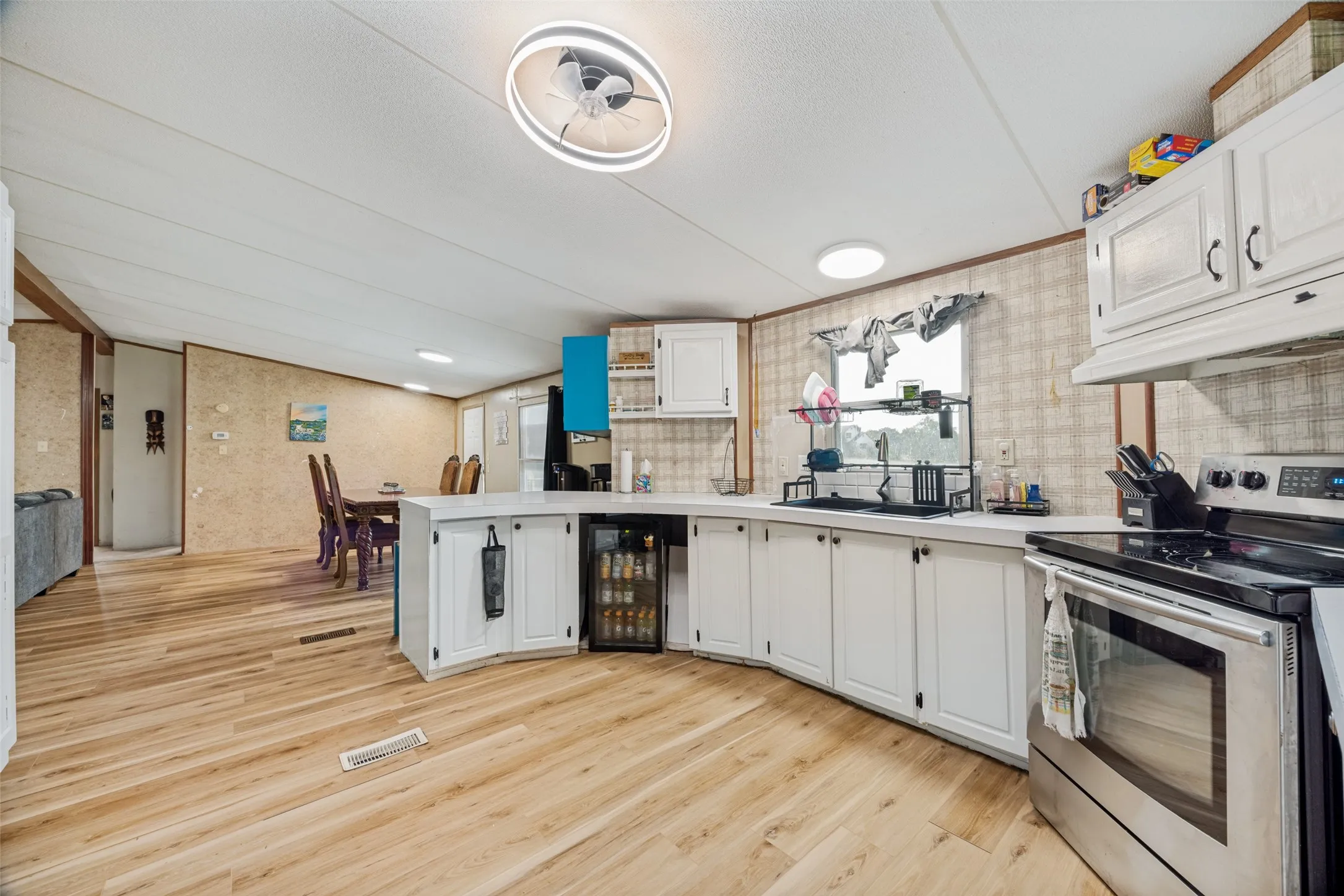 Kitchen features the space to install a dishwasher, as it is plumbed and wired for one.  The under counter chiller is not included as it is not affixed.  Subfloor to be repaired or replaced in several spots as there appears to be soft. Seller is selling as-is.