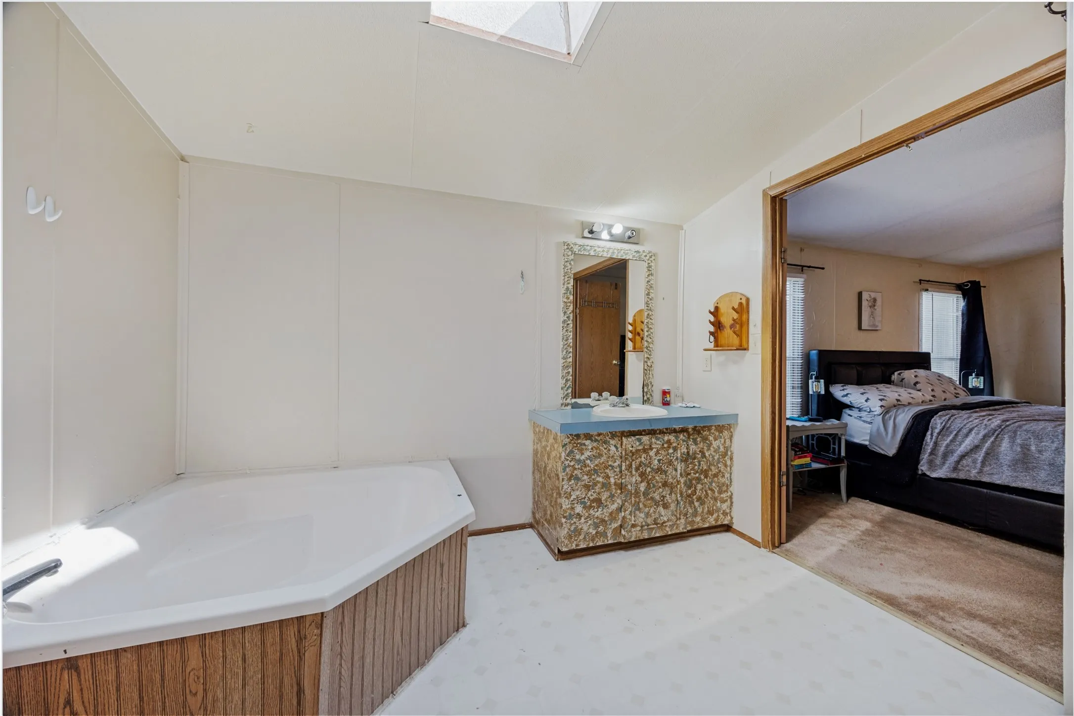 13x 10 Primary Bathroom featuring a corner soaking tub. Double doors open up to the Primary Suite.