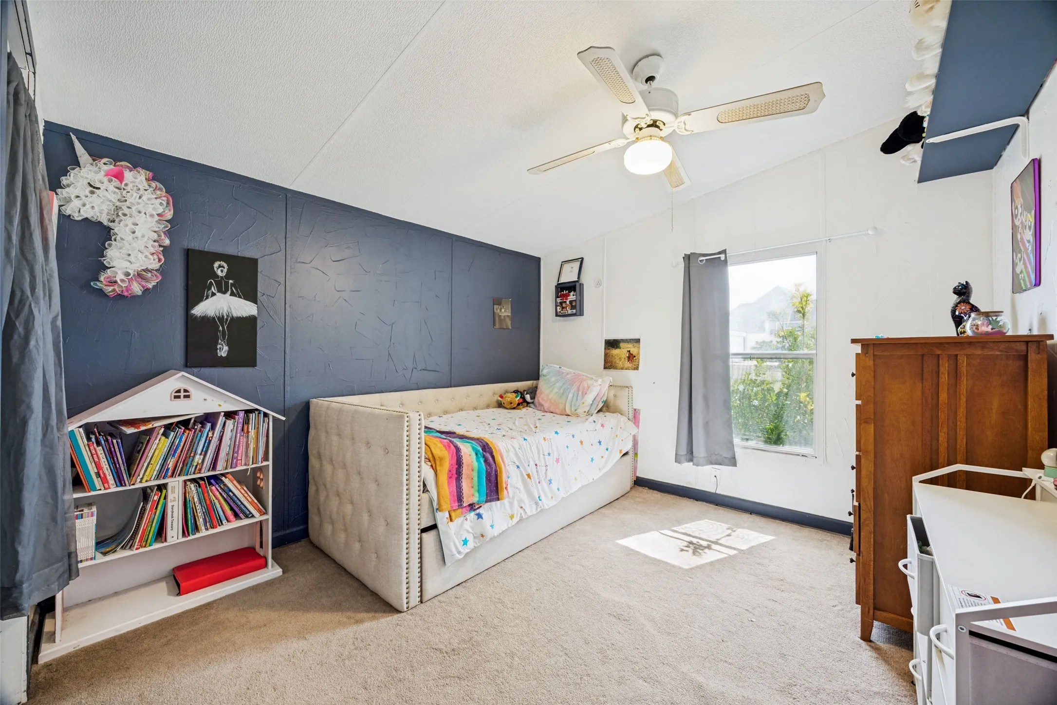 Bedroom#2 Measures 10x12 and features: textured accent wall, light-colored carpeting, ceiling fan, accent wall.