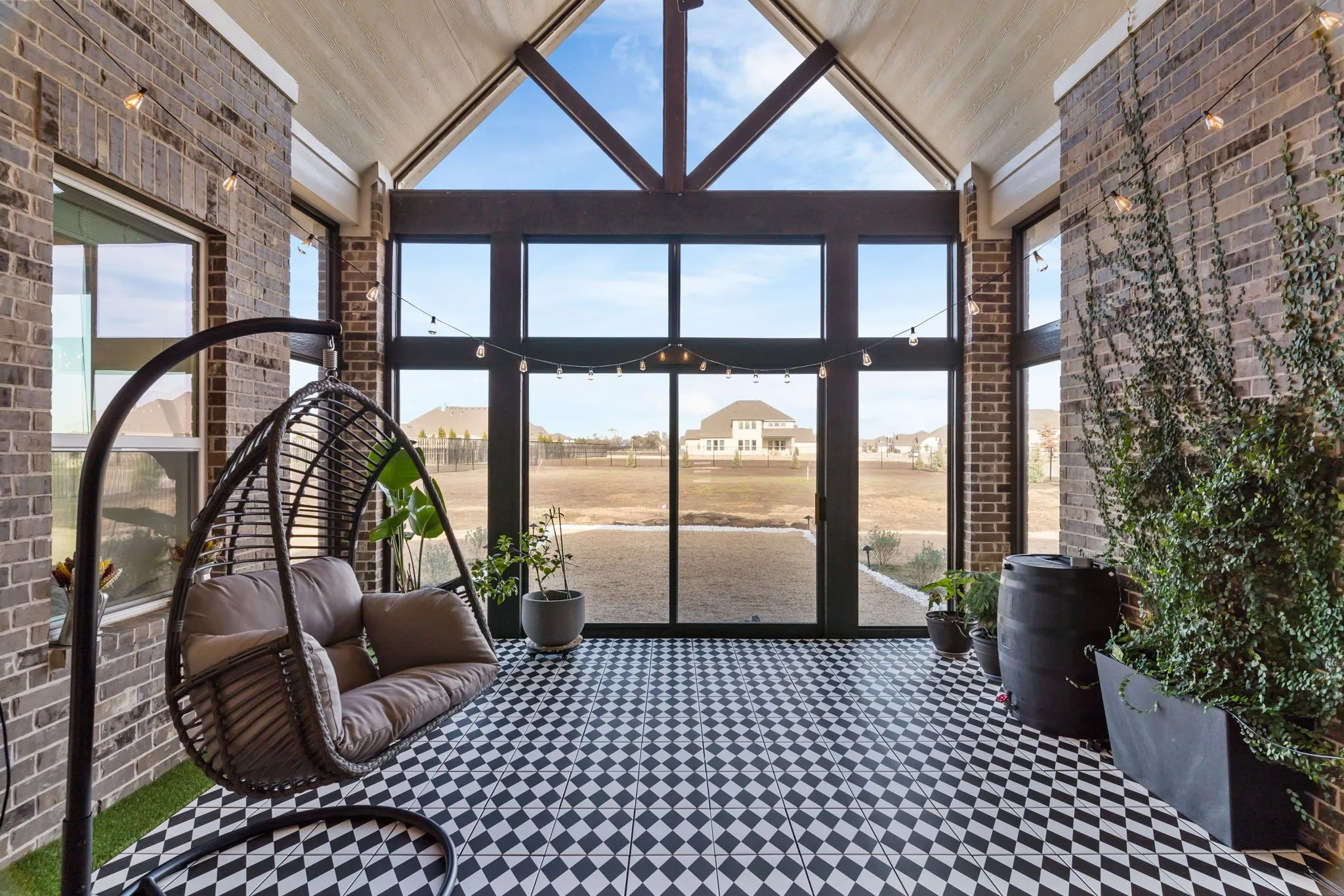 Enclosed tiled sun room with a healthy amount of natural sunlight