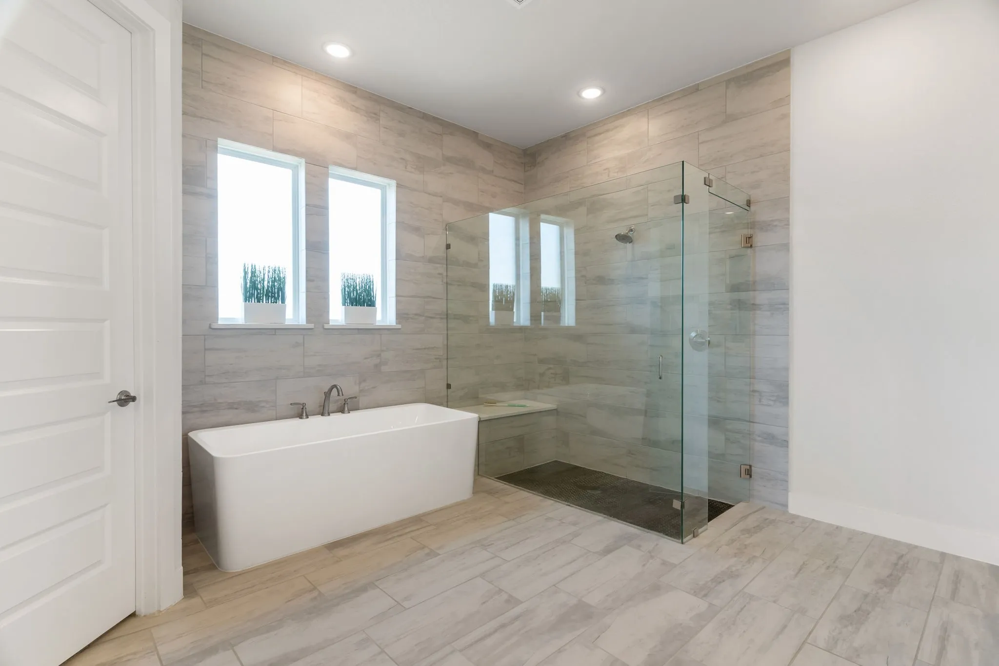 Primary bathroom with a walk in shower and stand alone garden tub