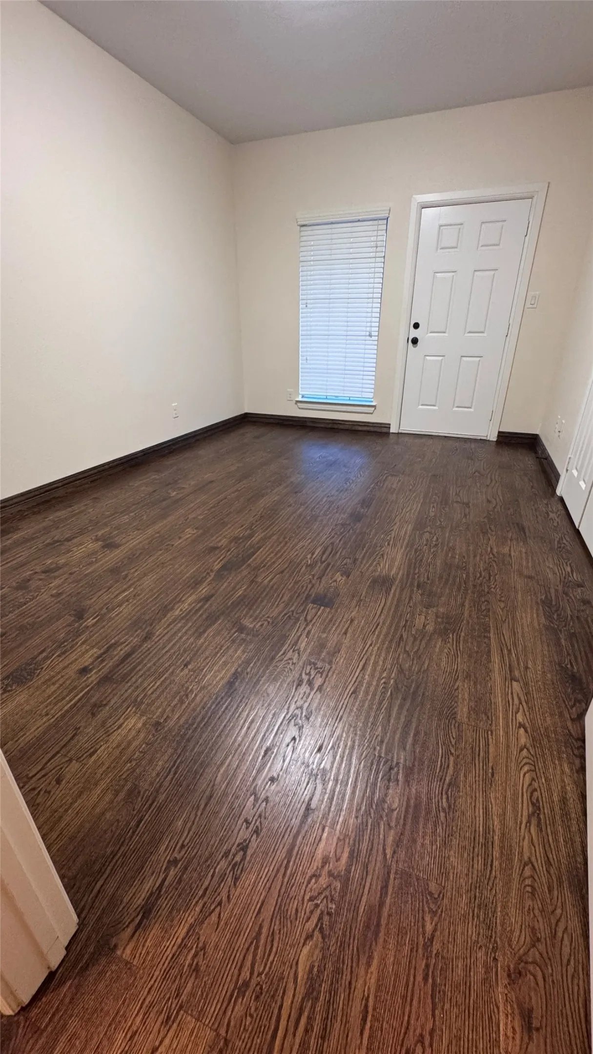 New hardwood floor in bedroom leading to patio on second floor