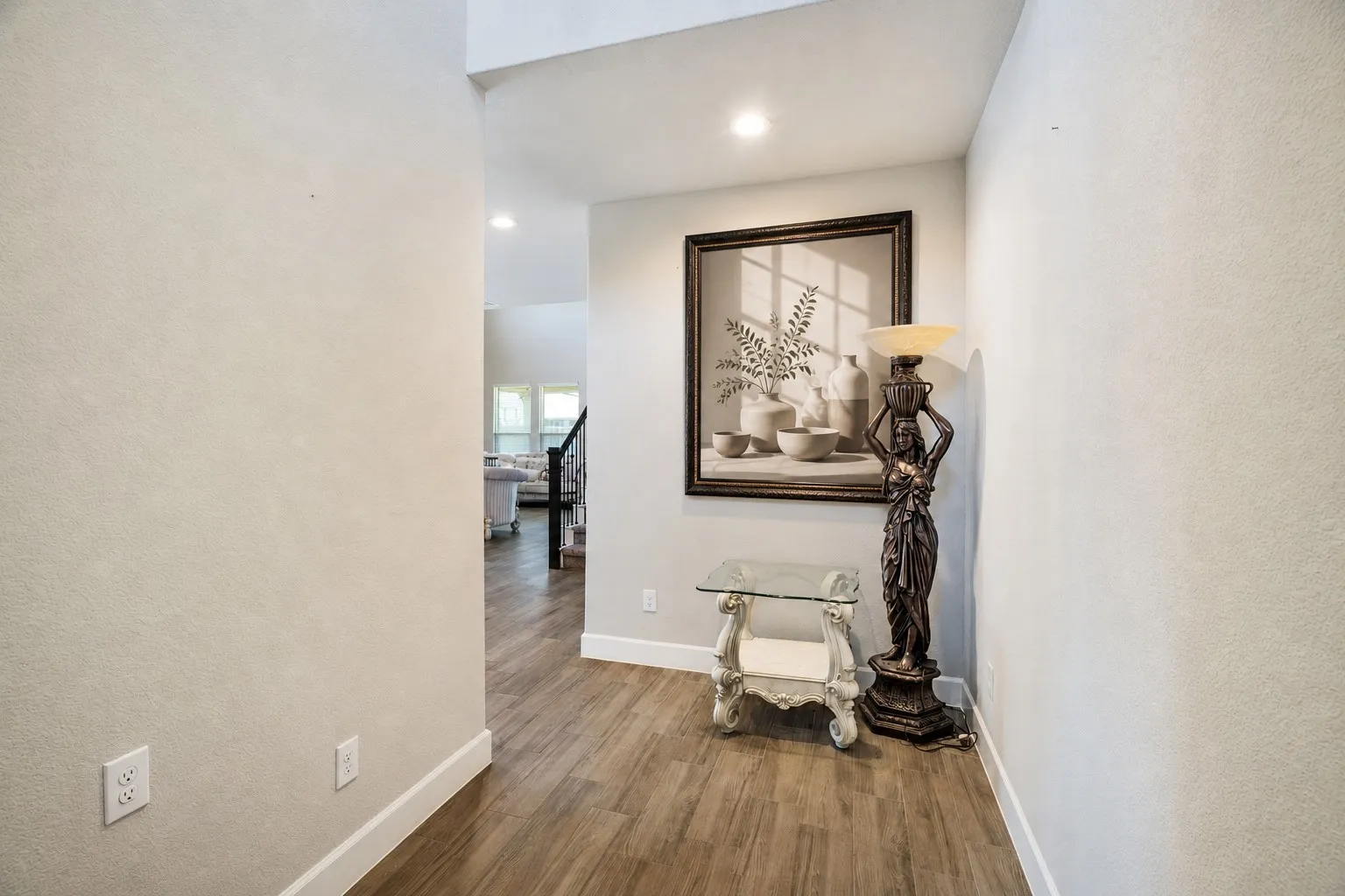 Hallway featuring wood-finish flooring and neutral wall tones