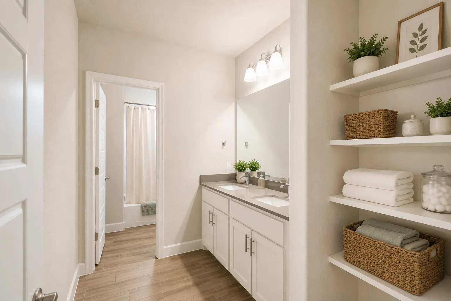 Bathroom featuring a double vanity with stone countertops, a large mirror, and three-light sconce-virtually staged with the cabinet decor