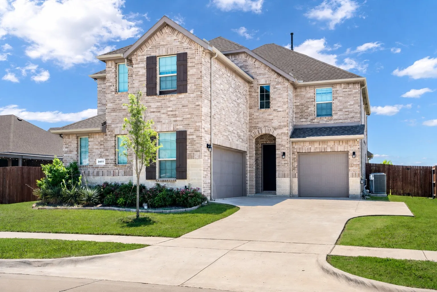 Brick exterior with stone accents and dark shutters