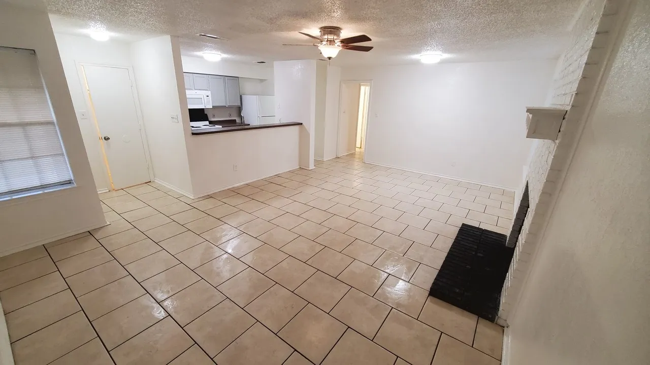 open area living and dining areas with fireplace