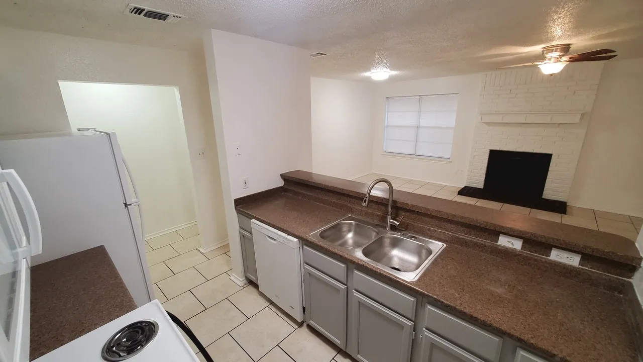 good size kitchen with new fridge, sink and kitchen faucet. with full size washer and dryer connection