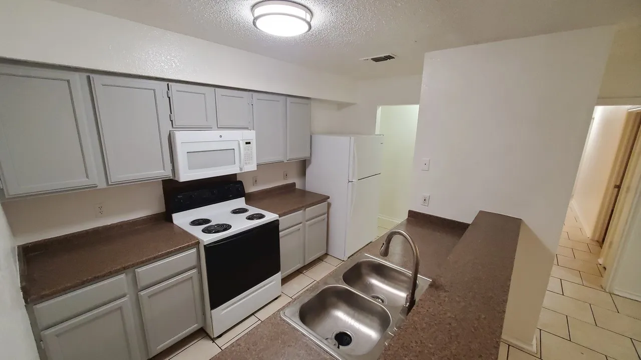 good size kitchen with new fridge, sink and kitchen faucet. with full size washer and dryer connection